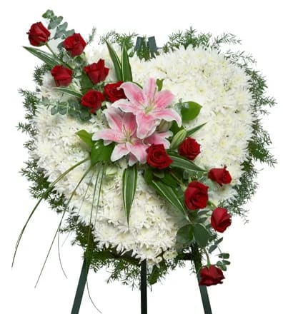 Heart-shaped white mum wreath with red roses and pink lilies on a standing easel