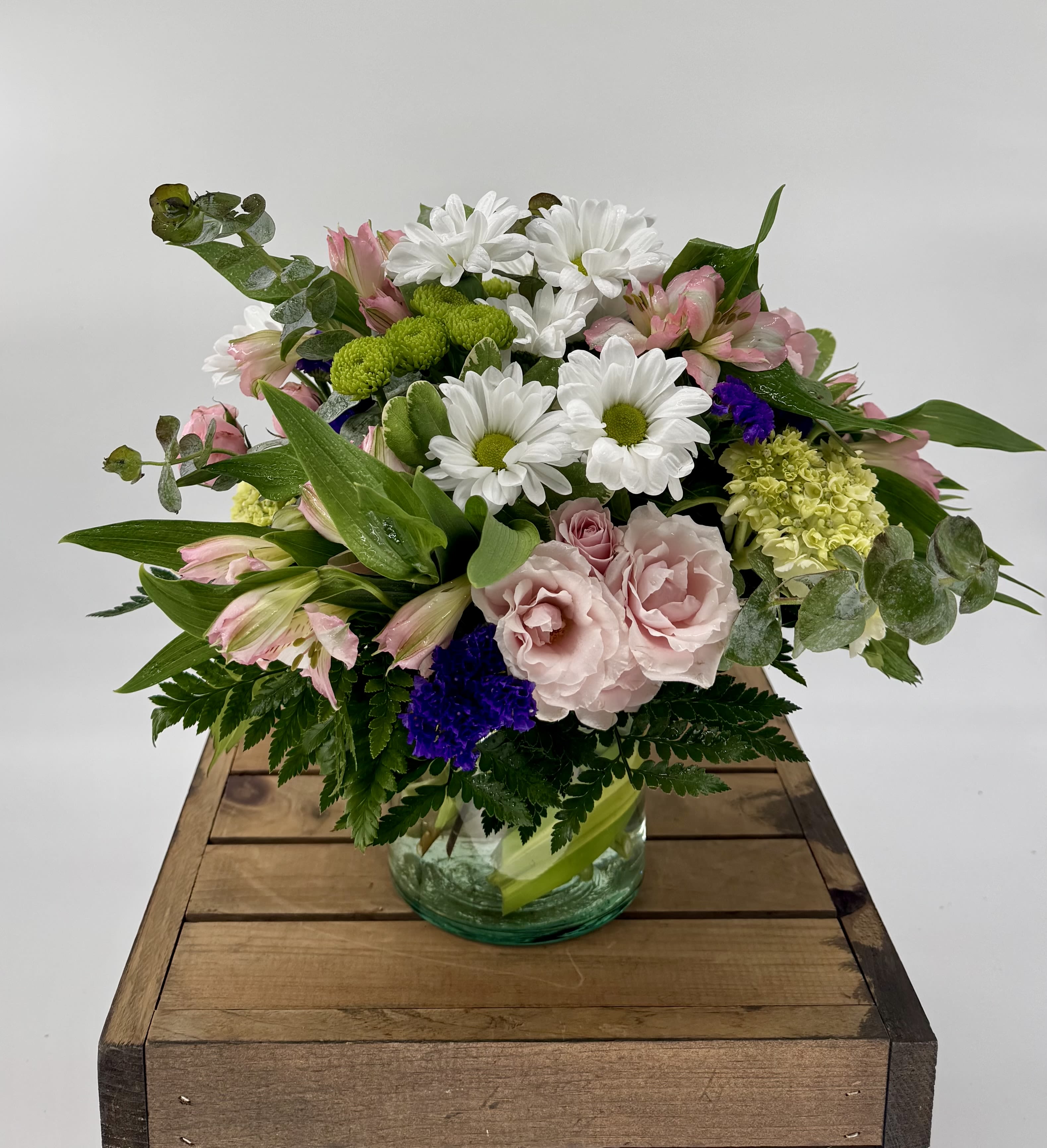 Fluttering Light (BR) - Our charming Fluttering Light flower arrangement, filled with green hydrangea, pink spray roses, white daisies, purple Statice, pink carnations, and pink alstroemeria, will leave you enchanted with its simple beauty. This delightful arrangement captures the essence of springtime, radiating a sense of cheerfulness, joy, and optimism.