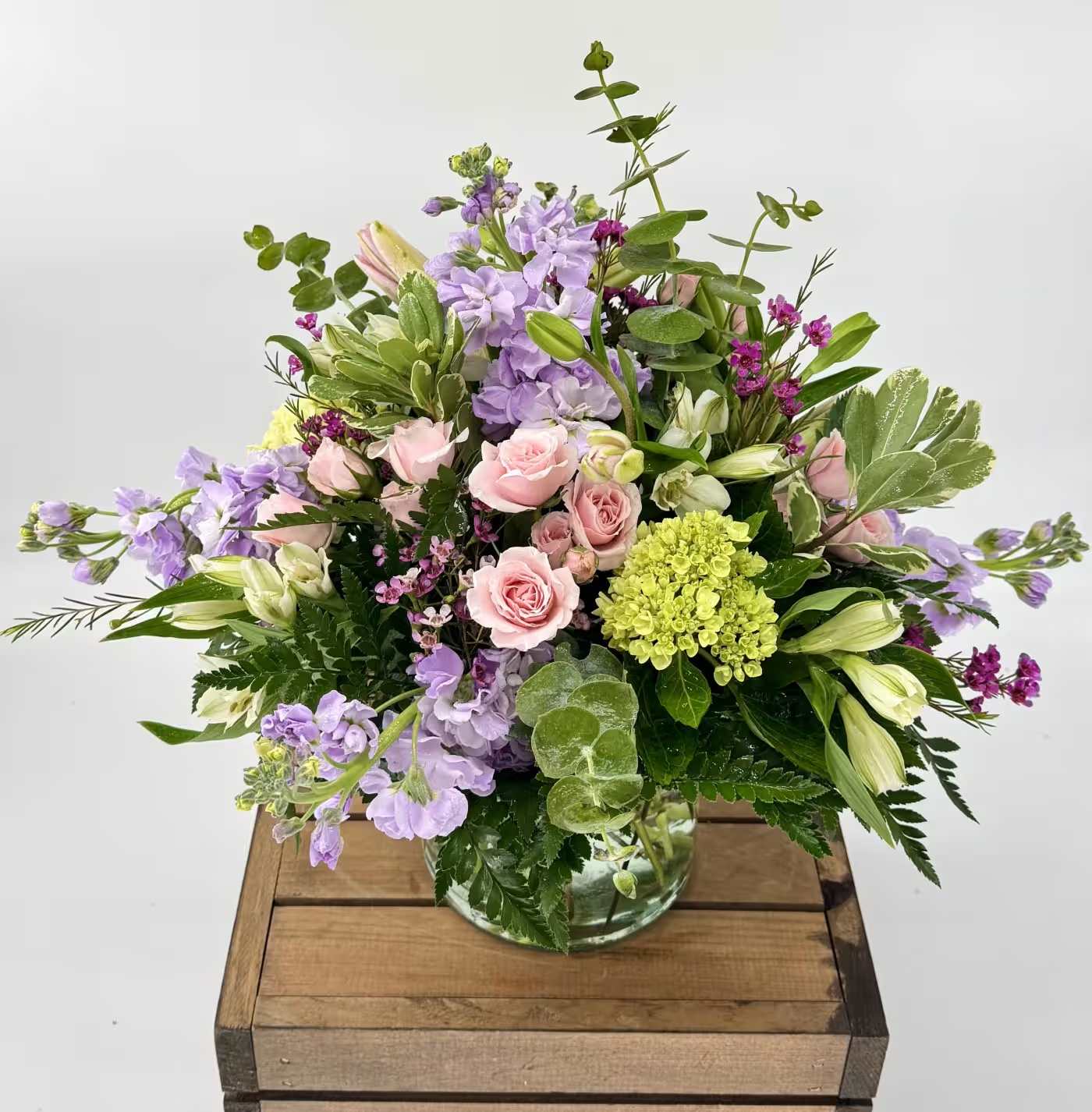 Delighted in Boynton (BB) - The Delighted in Delray floral arrangement is a burst of vibrant color, featuring a captivating combination of lilies, stock, hydrangea, spray roses, and gerberas. Set in a stunning glass vase adorned with shades of pink, green, and orange, this arrangement is a true feast for the eyes.