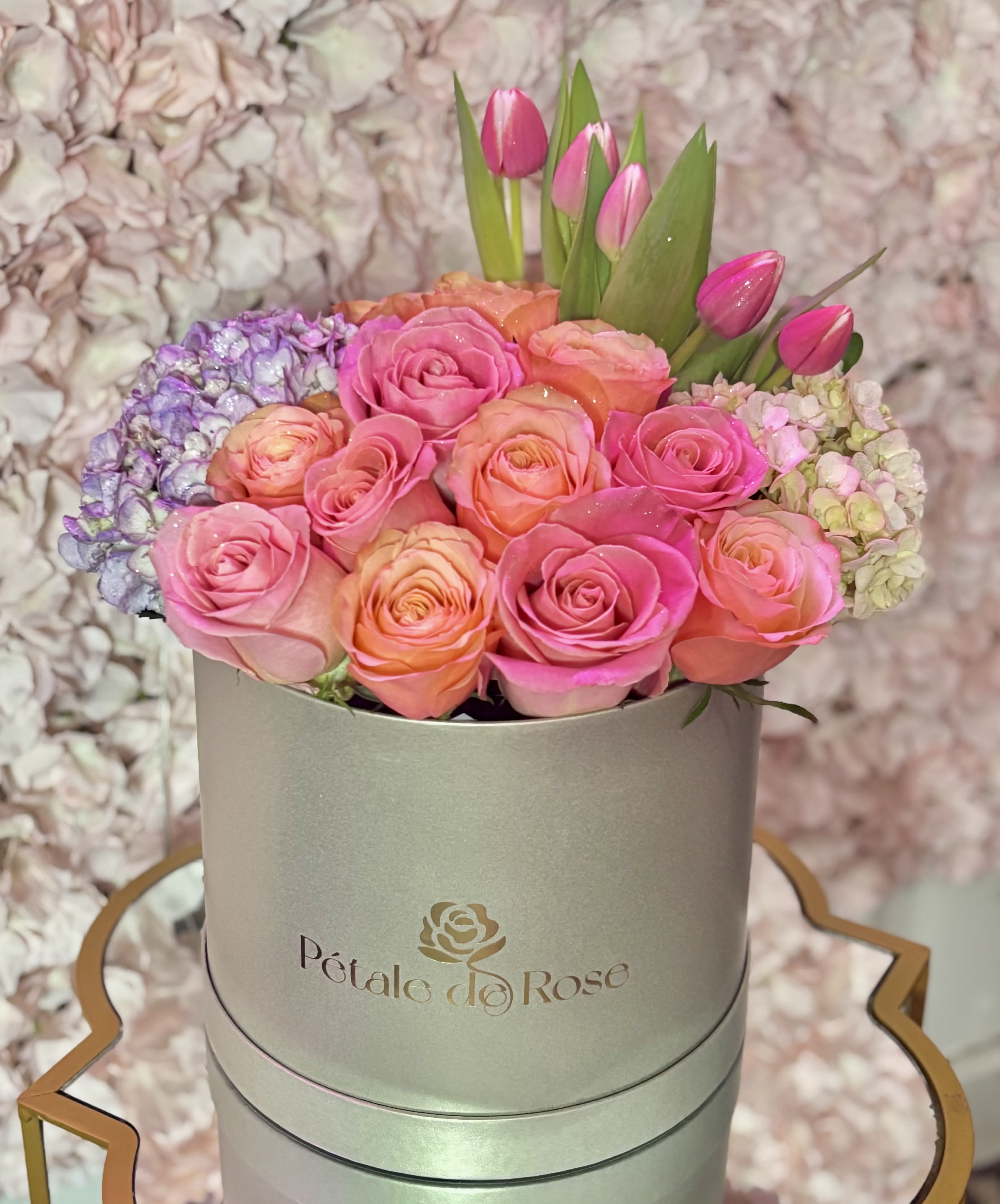 Blush Garden - A soft and elegant floral design inspired by the beauty of spring gardens  Featuring premium roses, tulips, and hydrangeas arranged in our signature luxury presentation.  Perfect for birthday, anniversaries gifting and creating unforgettable moments.  Please note: Flower substitutions and shades may vary based on seasonal and market availability. Our designers will always maintain the overall color palette, freshness, style, and luxurious feel of the arrangement shown.