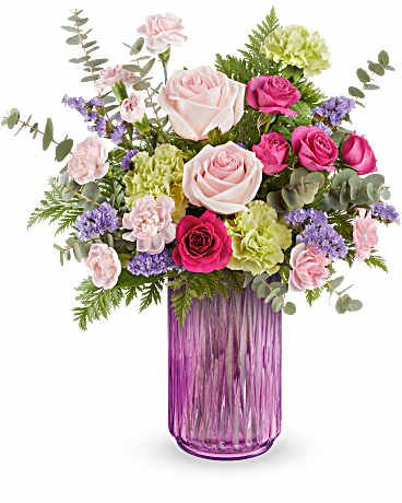 Pink and white rose bouquet in a purple glass vase