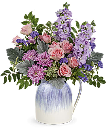 Pour on the Pretty Bouquet - This spring, pour on the pretty with lush pastel blooms presented in this charming ceramic pitcher with iridescent lavender glaze. It's food safe for years of versatile enjoyment!  Pink spray roses, lavender stock, lavender cushion spray chrysanthemums and purple sinuata statice are arranged with dusty miller, huckleberry and pitta negra. Delivered in a Pour on the Pretty pitcher.  SUBSTITUTION POLICY – Always deliver the freshest flowers! Please note the bouquet pictured reflects our original design.  If the exact flowers or container in this arrangement are not available, we will create a beautiful bouquet with the freshest available flowers.