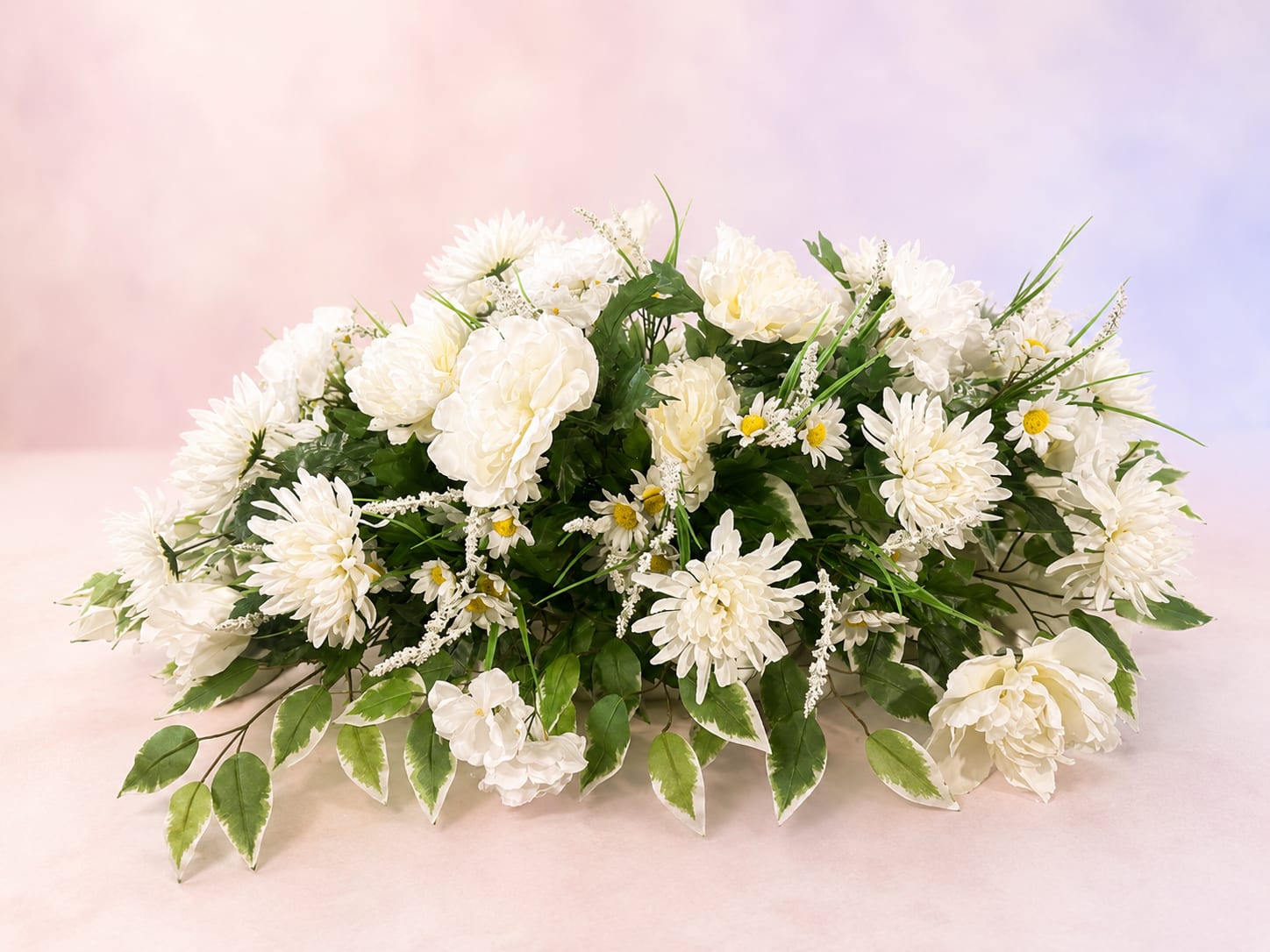 Peaceful Garden Tribute - Peaceful Garden Tribute is a graceful silk sympathy arrangement designed in soft white florals with lush greenery accents for a timeless and elegant presentation. Featuring delicate daisies, full blooms, and flowing textures, this arrangement offers a comforting expression of love, remembrance, and peace. Its serene all-white palette makes it a beautiful choice for funeral services, memorials, or graveside tributes, creating a lasting keepsake to honor a cherished life.