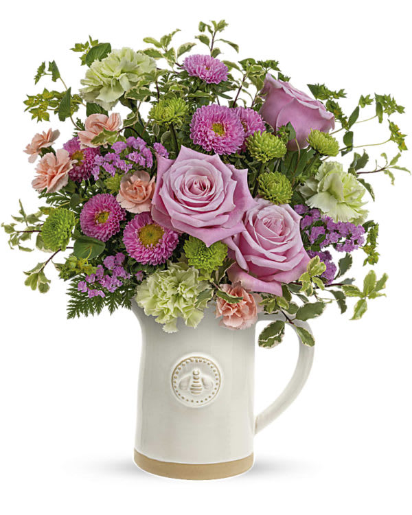 Queen Bee Artisnal Pitcher Bouquet - With its charming sculpted bee detail and artisanal glazed finish, this food-safe stoneware pitcher makes a delightful gift filled with fresh pink blooms!  This perky bouquet includes pink roses, green carnations, miniature peach carnations, pink matsumoto asters, green button spray chrysanthemums, pink sinuata statice, bupleurum, pitta negra and leatherleaf fern. Delivered in an Artisanal Pitcher.  SUBSTITUTION POLICY – Always deliver the freshest flowers! Please note the bouquet pictured reflects our original design.  If the exact flowers or container in this arrangement are not available, we will create a beautiful bouquet with the freshest available flowers.