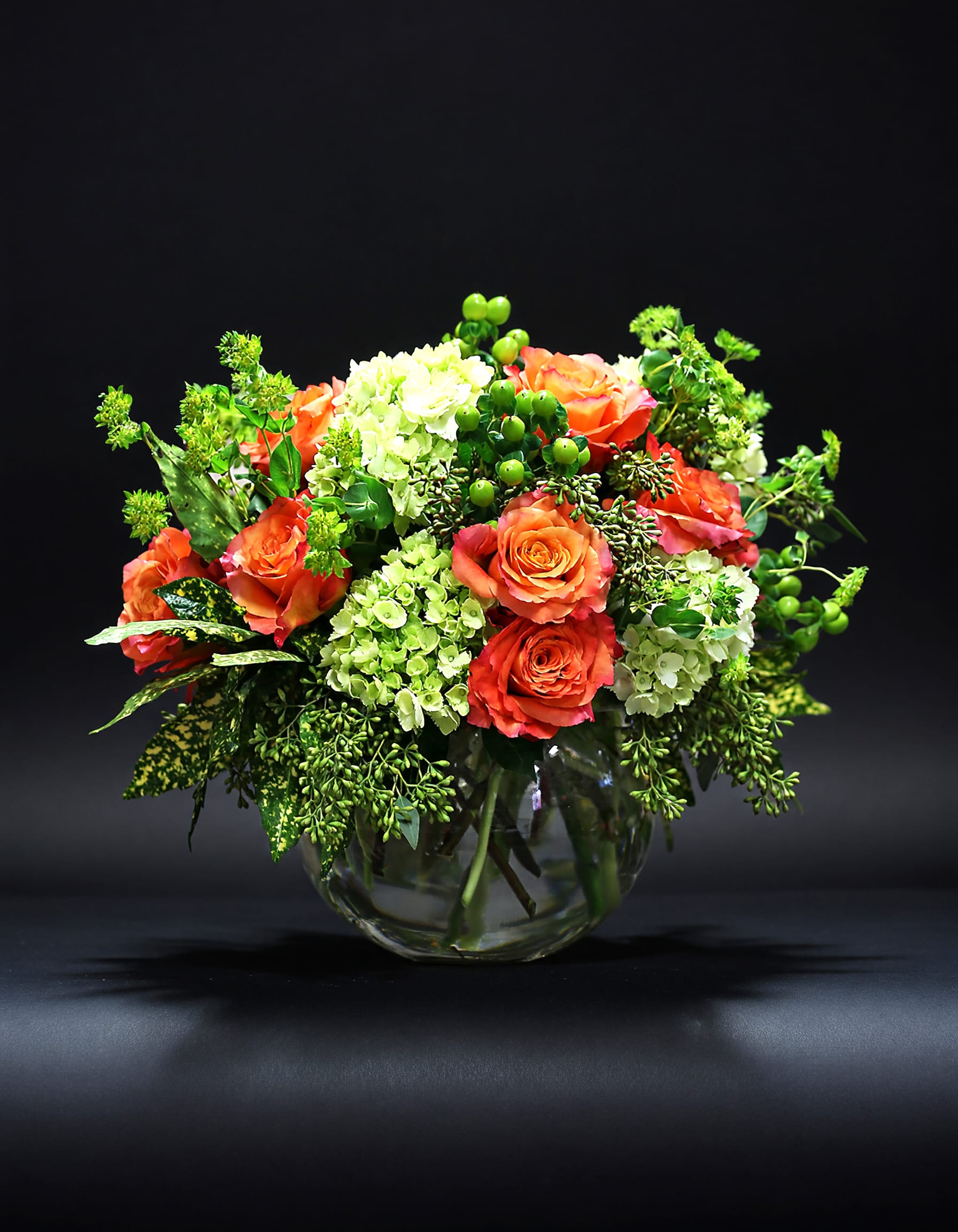 Mozart - The tune in your head translates into a melodic combination of orange and green notes that will keep you humming! A compilation of hard and soft textures work together in perfect harmony to create a happy place for your heart. Presented in a clear glass bubble bowl with exposed stems