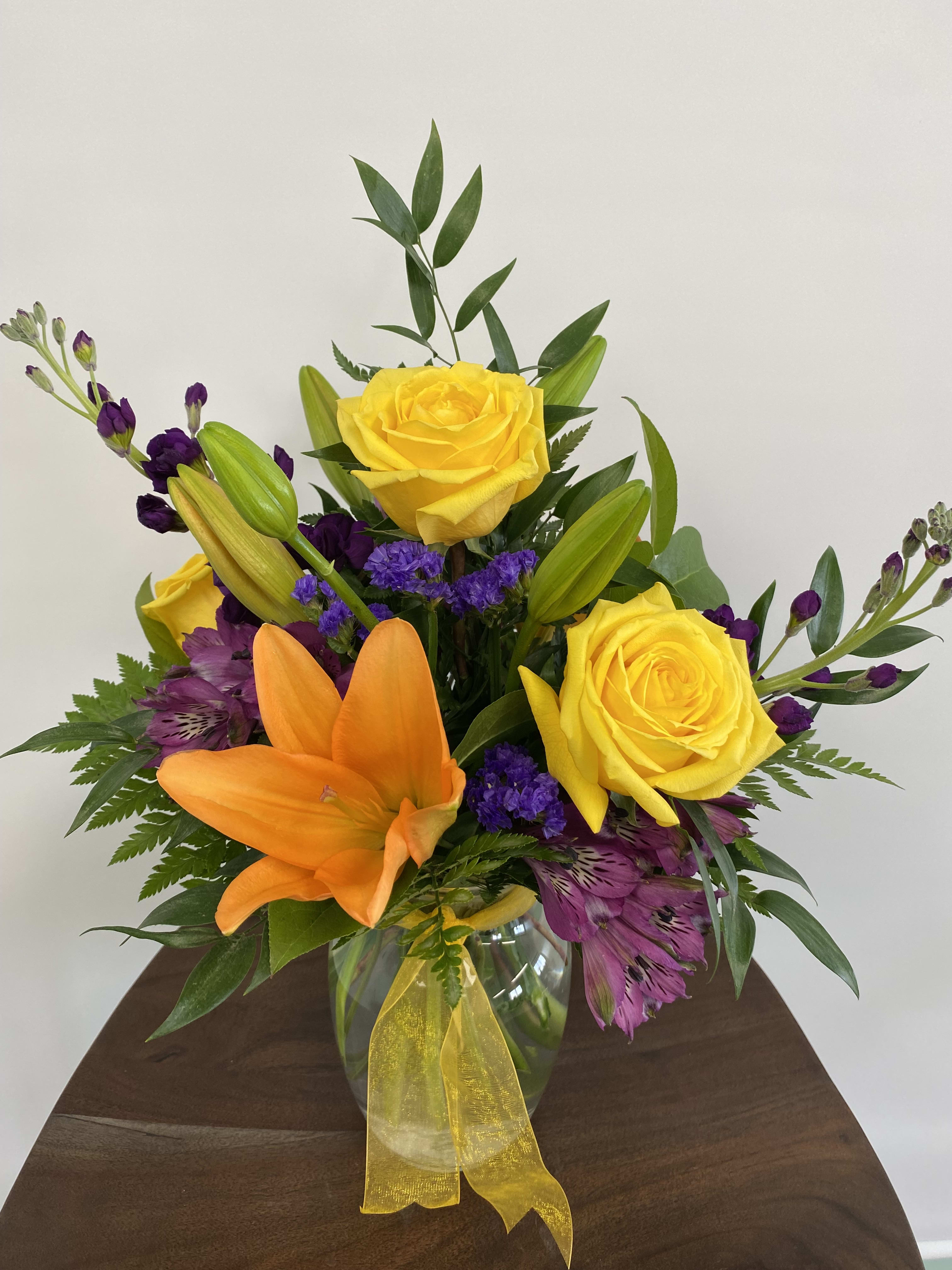 Vibrant - Bold colors make this arrangement pop!   Approx. 10” X 8”