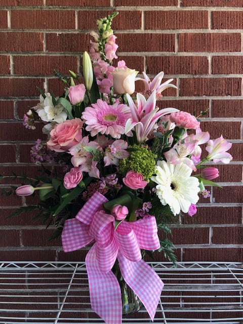 Pink and white mixed bouquet in a glass vase with a gingham bow