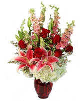 Red roses and pink lilies in a red vase
