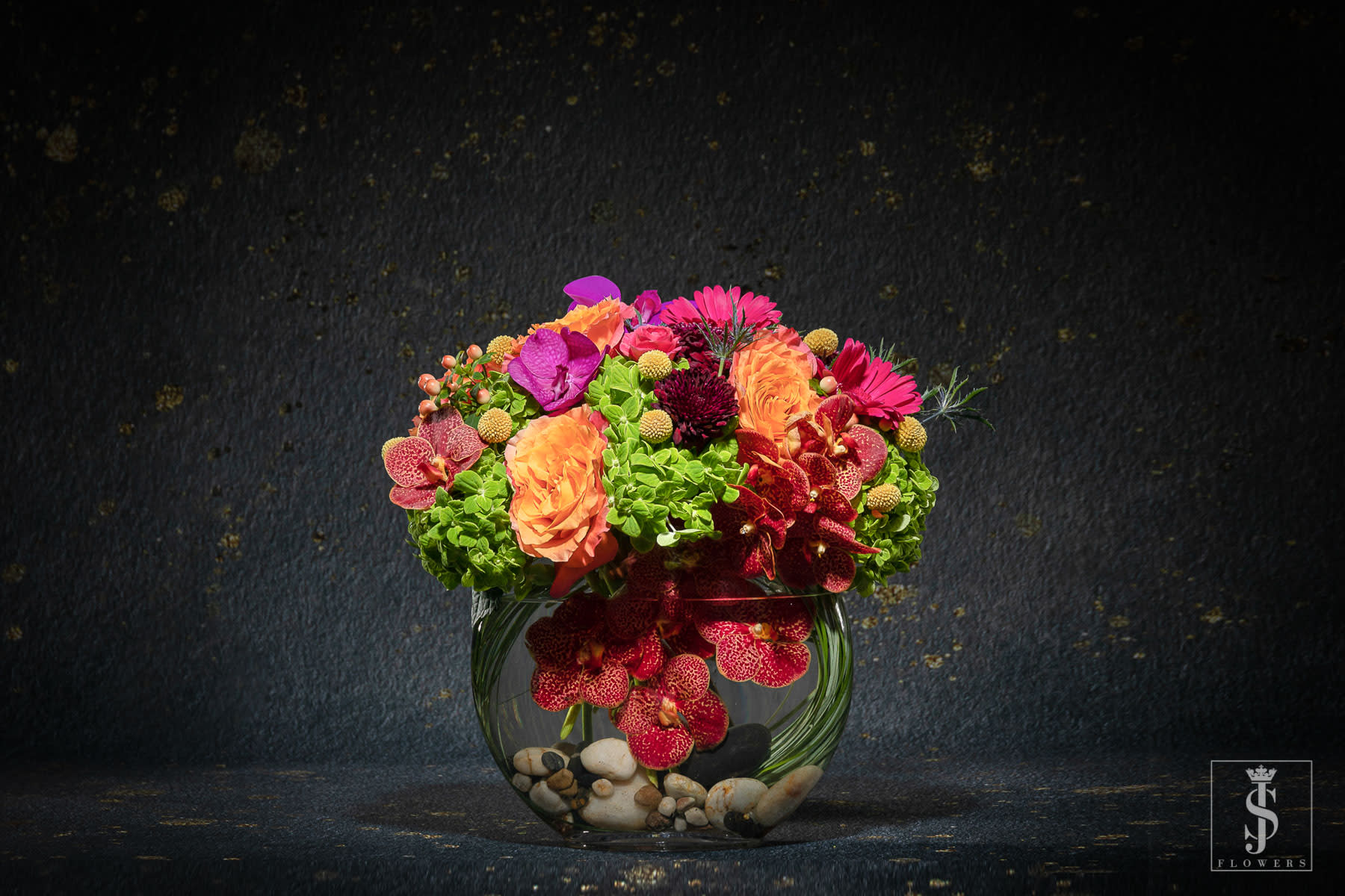 Colorful mixed flower arrangement in a glass bowl vase