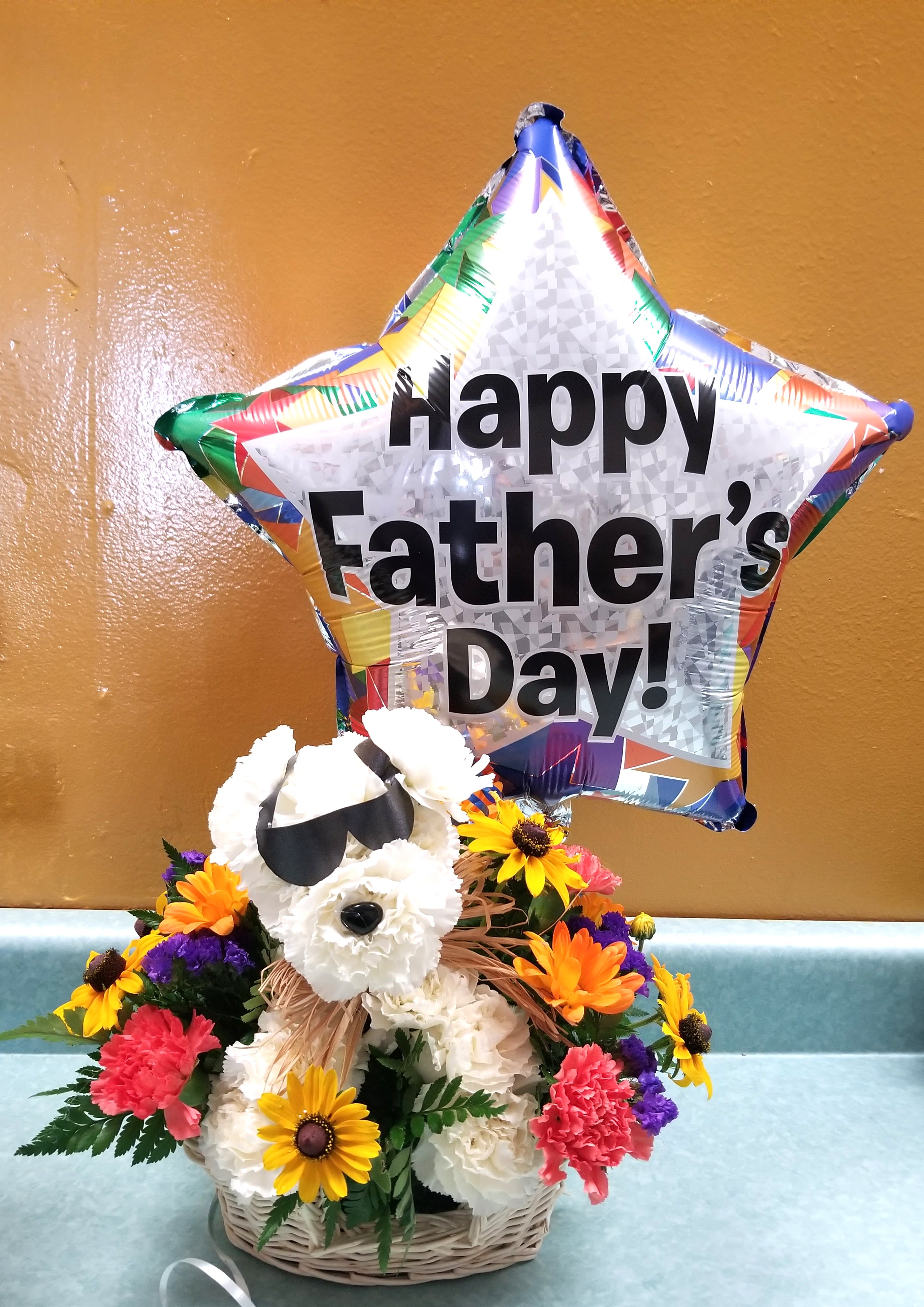 BASKET ARRNGEMENT IN A BASKET WITH PUPPY AND BALLOON - YELLOW ORANGE FLOWERS AND PUPPY WITH BALLOON OR WITH ALL BLUE OR YELLOW ROSES FOR 124.99