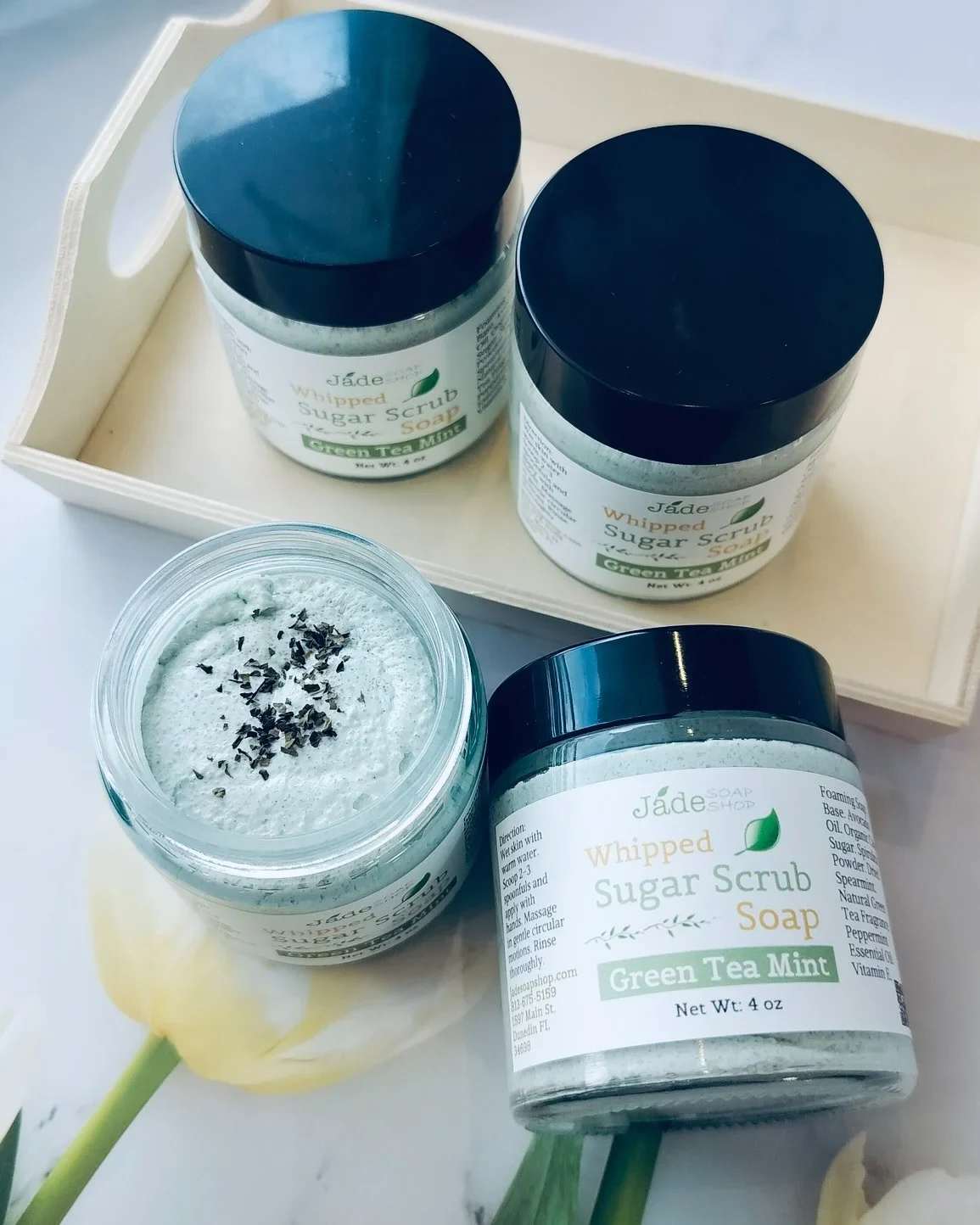 Whipped Sugar Scrub Soap - Green Tea Mint - Whipped Sugar Scrub Soap - Green Tea Mint Exfoliate • Cleanse • Refresh  Indulge in the perfect balance of gentle exfoliation and creamy lather with our Green Tea Mint Whipped Sugar Scrub Soap. This luxurious 3-in-1 formula combines the cleansing power of soap with the skin-polishing benefits of a sugar scrub—leaving your skin feeling soft, smooth, and invigorated. Infused with antioxidant-rich green tea and cooling peppermint essential oil, this scrub awakens your senses while helping to remove dead skin cells and promote healthy-looking skin. The addition of avocado oil delivers deep nourishment, and dried spearmint and organic spirulina powder provide a natural touch of botanical goodness. Perfect for daily use in the shower or as a refreshing pick-me-up before a day out.  Ingredients: Foaming Bath Butter, Pure Cane Sugar, unrefined Avocado Oil, Organic Spirulina Powder, Dried Spearmint. Natural Fragrance Oil of Green Tea, Essential oil of Peppermint. Natural Preservative. Net Weight: 4oz