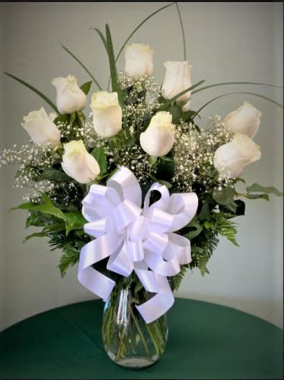 DOZEN WHITE ROSES - A classic dozen of our finest white roses are truly the height of indulgence. Spoil someone special with the gift of twelve ivory roses sitting sweetly amongst a spray of sparkling white gypsophila and emerald green leaves. 