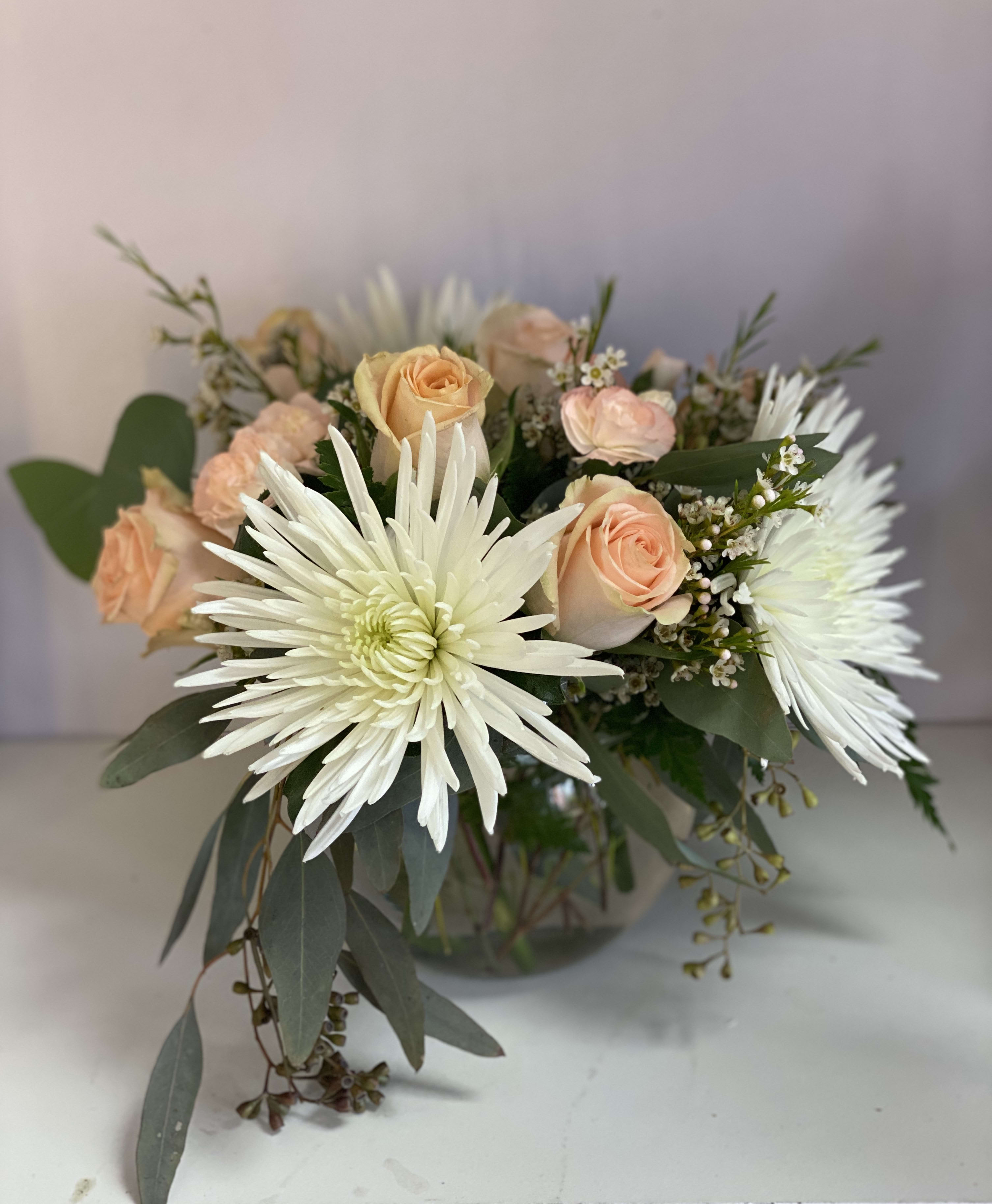 Sweet peach - This timeless classic of fresh peach roses, white spider mums all accented with seed eucalyptus and baby's breath.