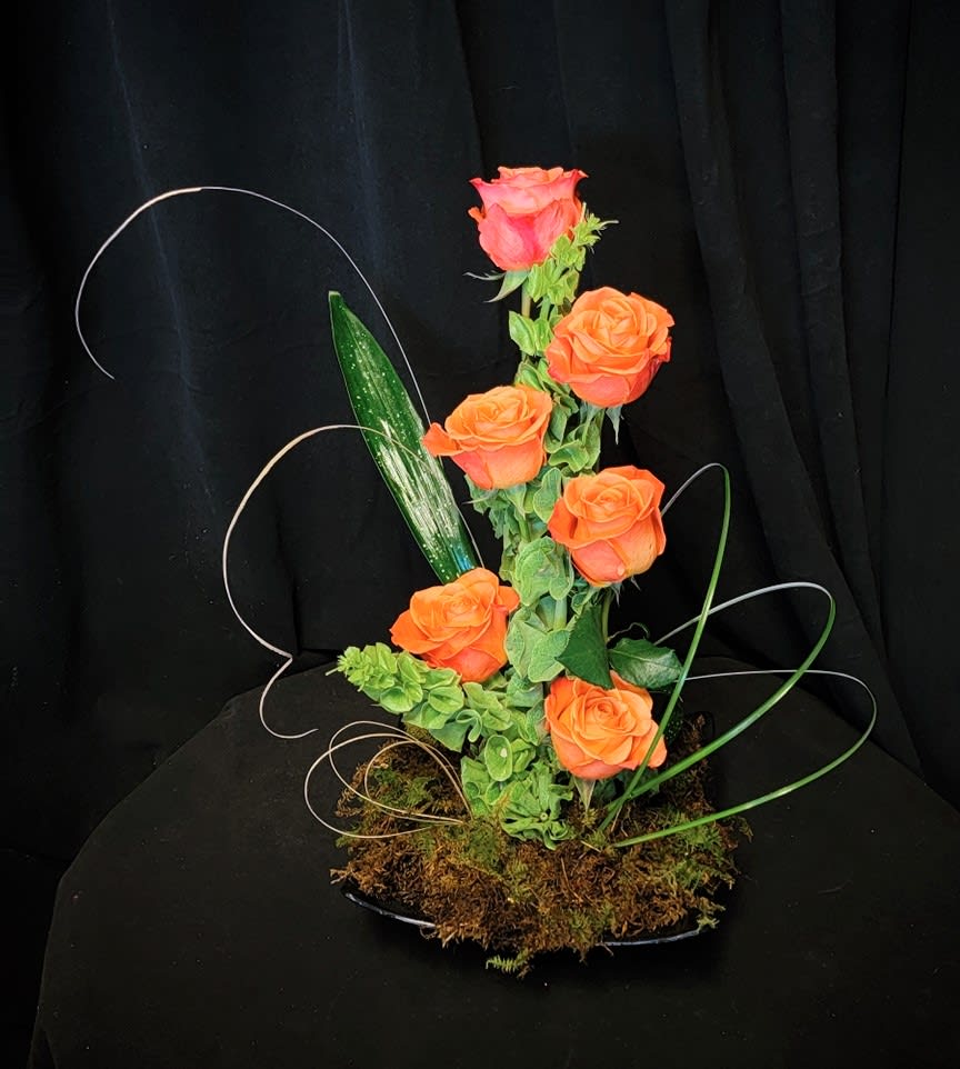 Orange Cascade - Cascading roses around bells of Ireland, for a dramatic effect.