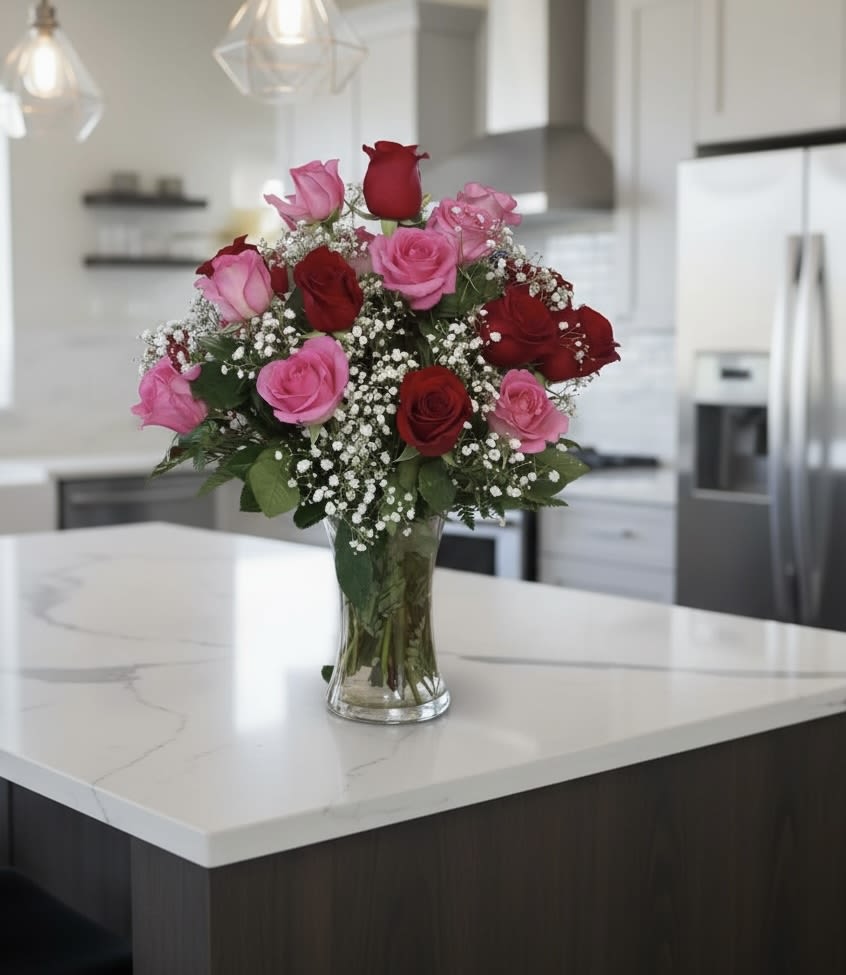 Bouquet of pink and red roses in a clear glass vase