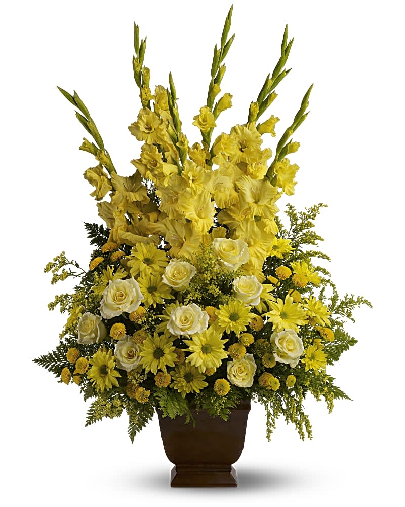 Yellow and white floral arrangement in a brown urn vase