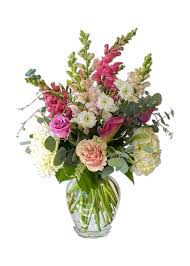 Mixed pink and white flowers in a clear glass vase
