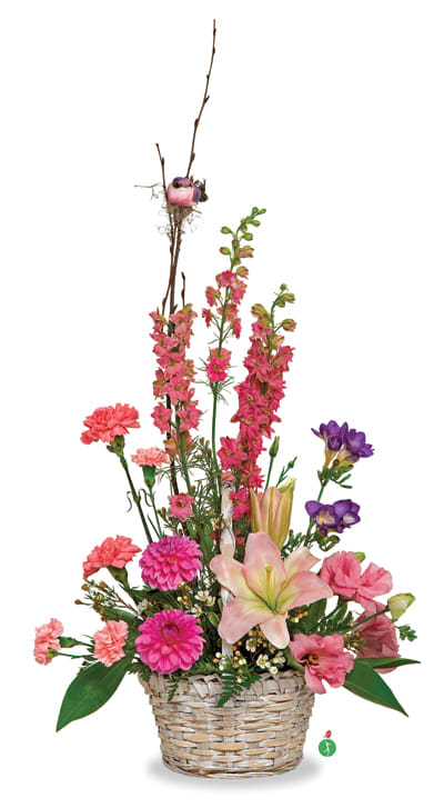Pink and purple mixed flower arrangement in a woven basket