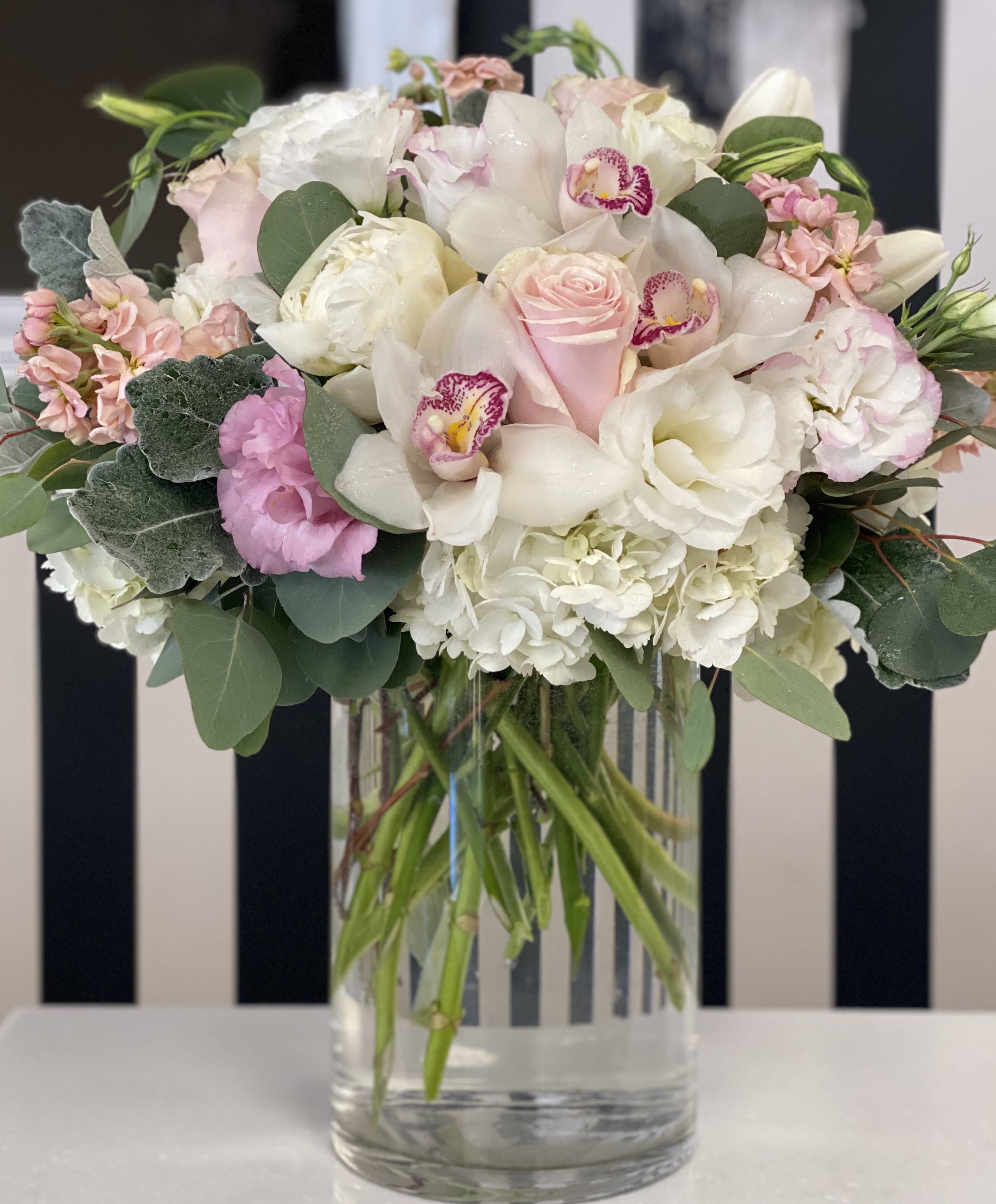 Pink and white bouquet in a clear glass vase