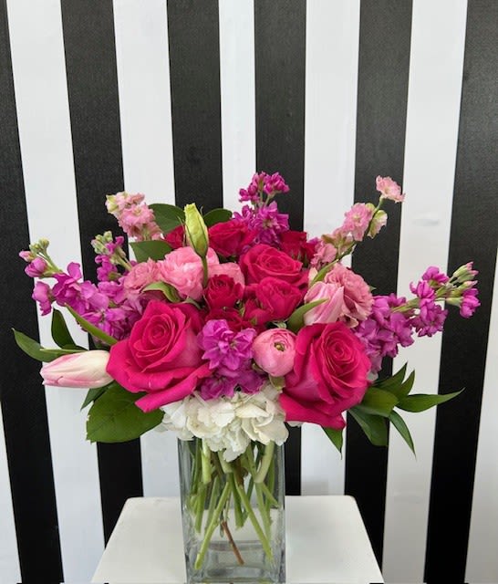 Pink and purple mixed bouquet in a clear glass vase