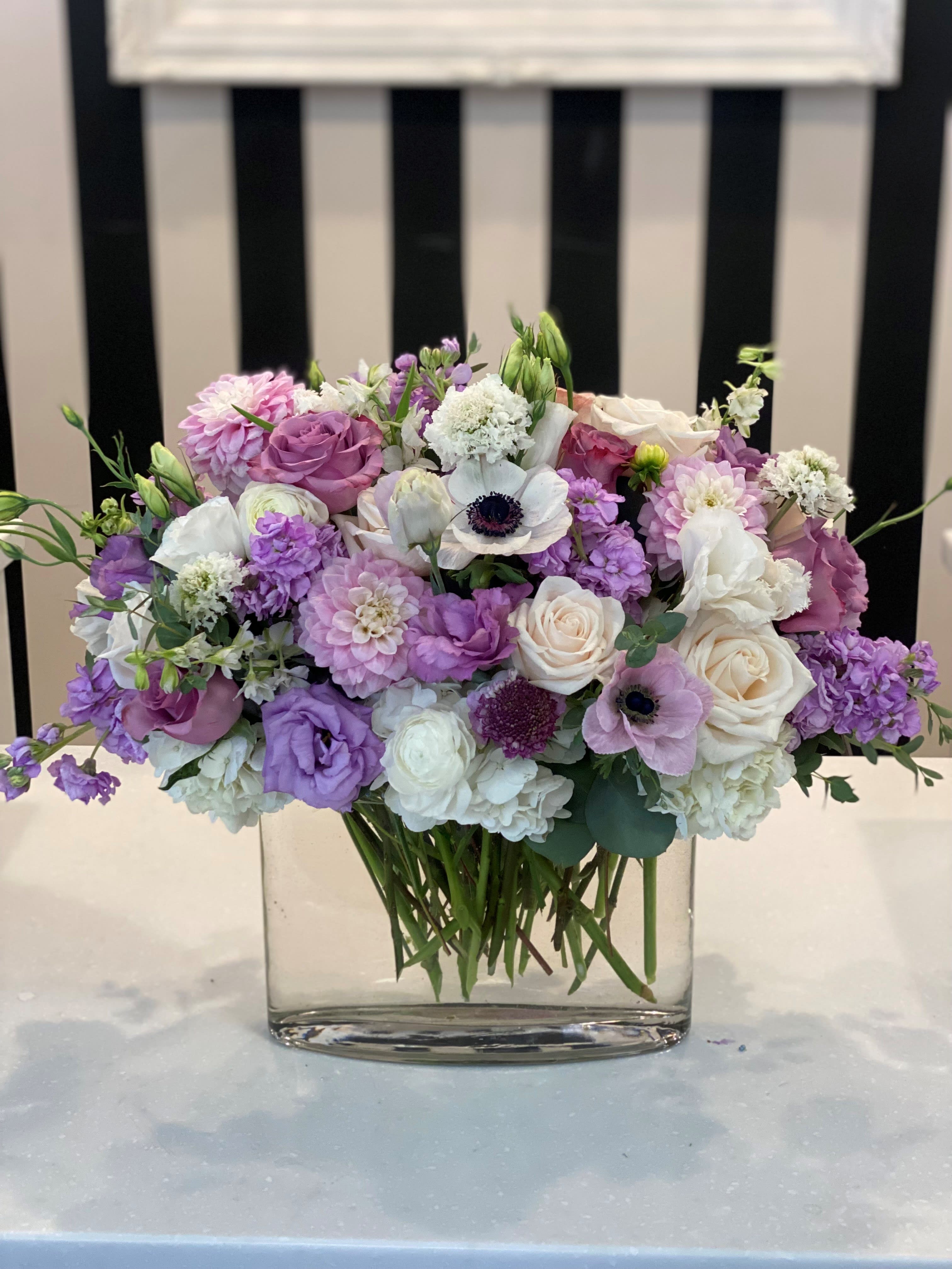 Lavender and white mixed bouquet in a clear glass vase