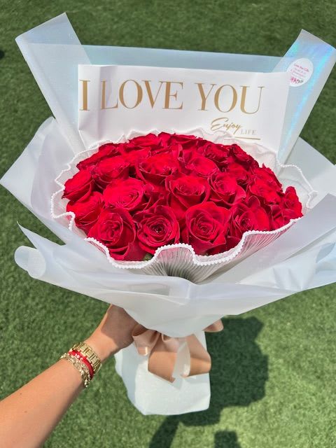 I Love You Red Rose Bouquet – Bold &amp; Elegant - Say it loud. Say it beautifully. Our I Love You Red Rose Bouquet showcases luxurious red roses wrapped in stunning white paper and highlighted with an elegant “I LOVE YOU” message for an unforgettable romantic statement.  Designed for those moments that deserve more than words, this bouquet is perfect for Valentine’s Day, proposals, anniversaries, or grand romantic gestures. Crafted with precision and passion, it delivers emotion at first sight.   Premium red roses  Elegant “I LOVE YOU” statement wrap  Luxury presentation  Same-day delivery available in Midland, Odessa &amp; surrounding areas  3 dozen 