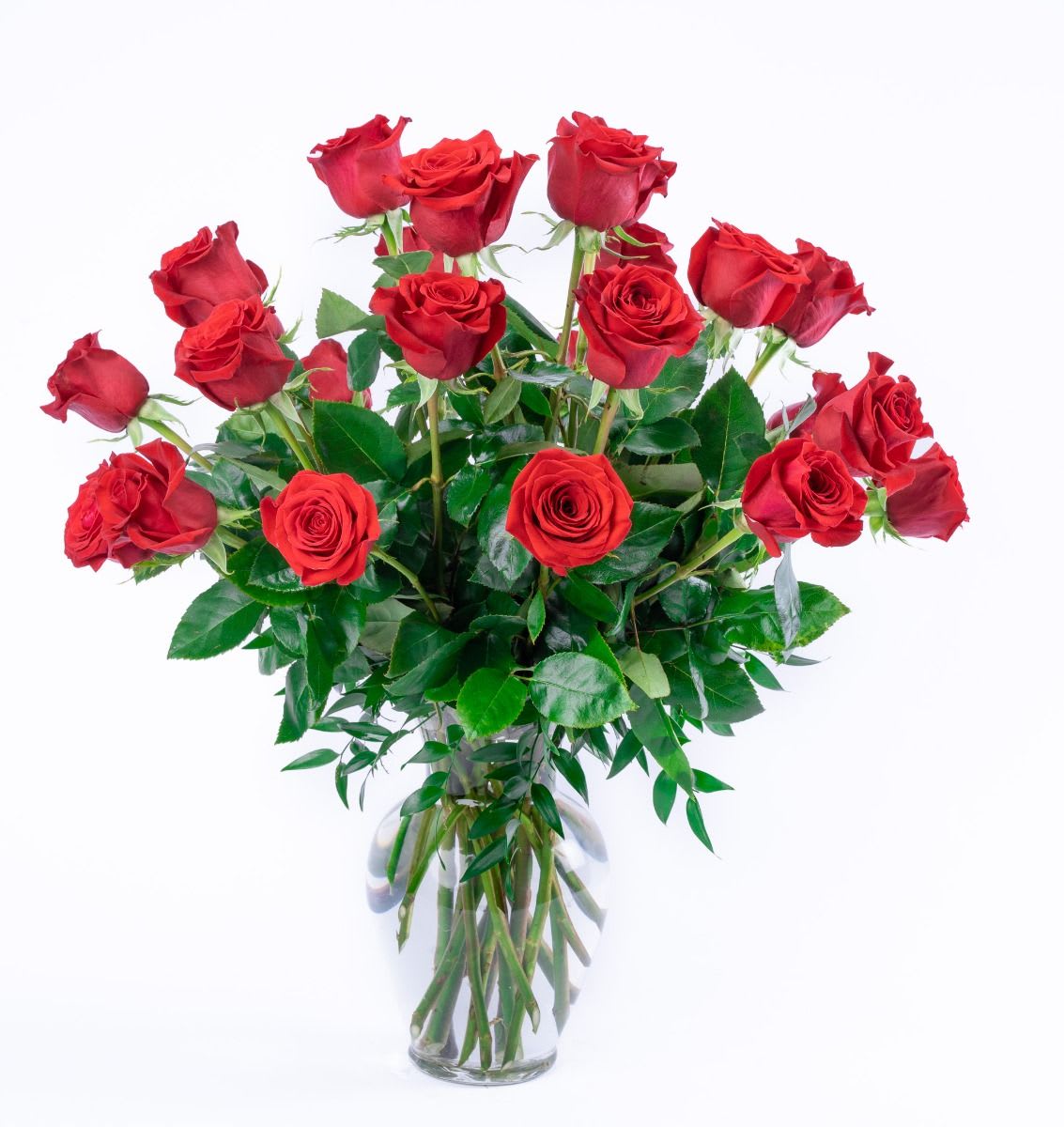 Tall bouquet of long-stemmed red roses in a clear glass vase