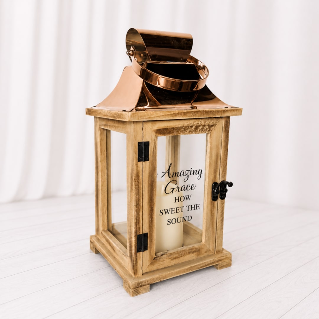 Wooden lantern With LED Candle  - A cream candle in a rustic wooden lantern with copper top and glass sides - warm, traditional décor perfect for memorial or cozy home accents. comes with batteries and a bow. 2 sayings available. Lantern is 12 inches tall.
