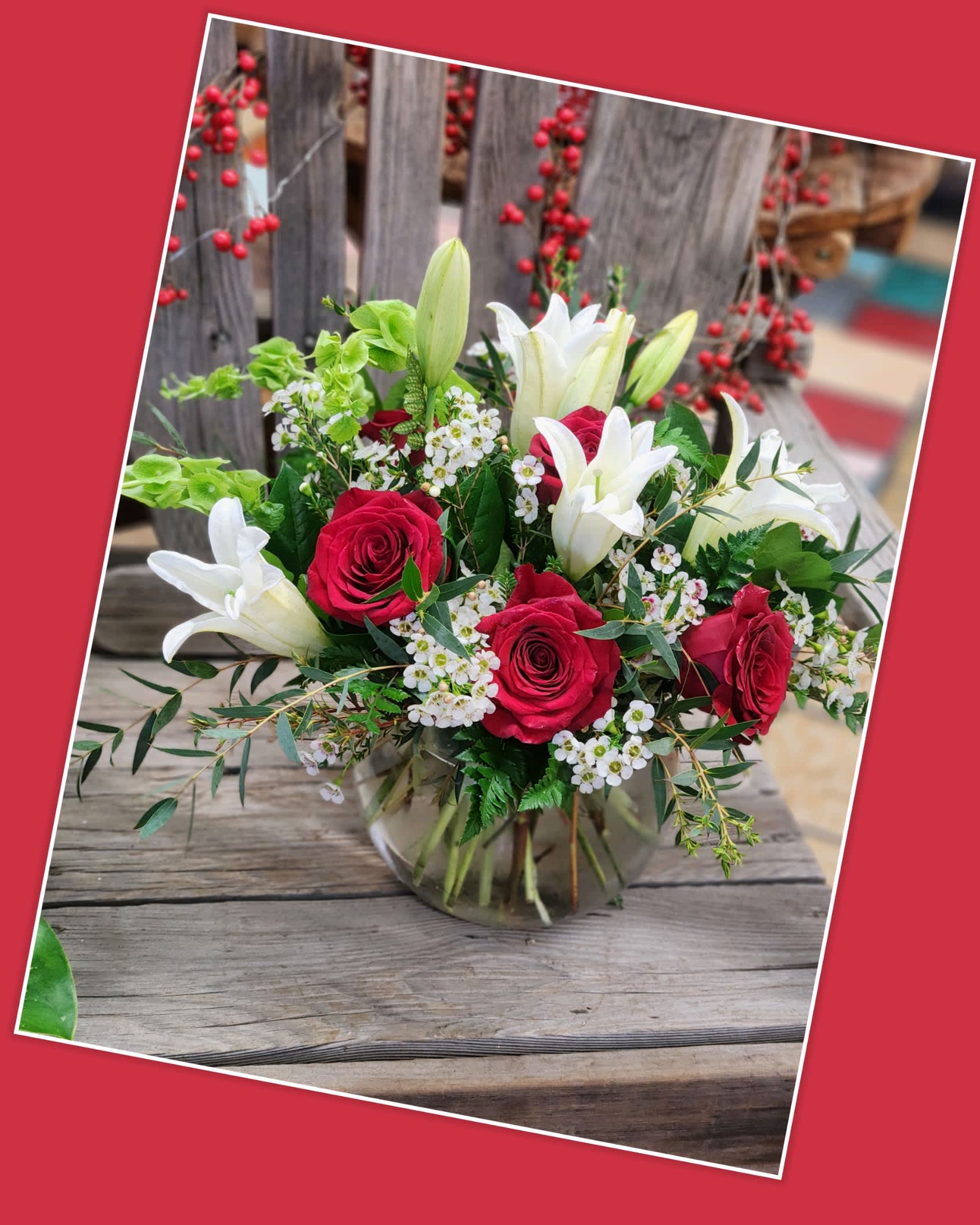 Red roses and white lilies in a glass vase
