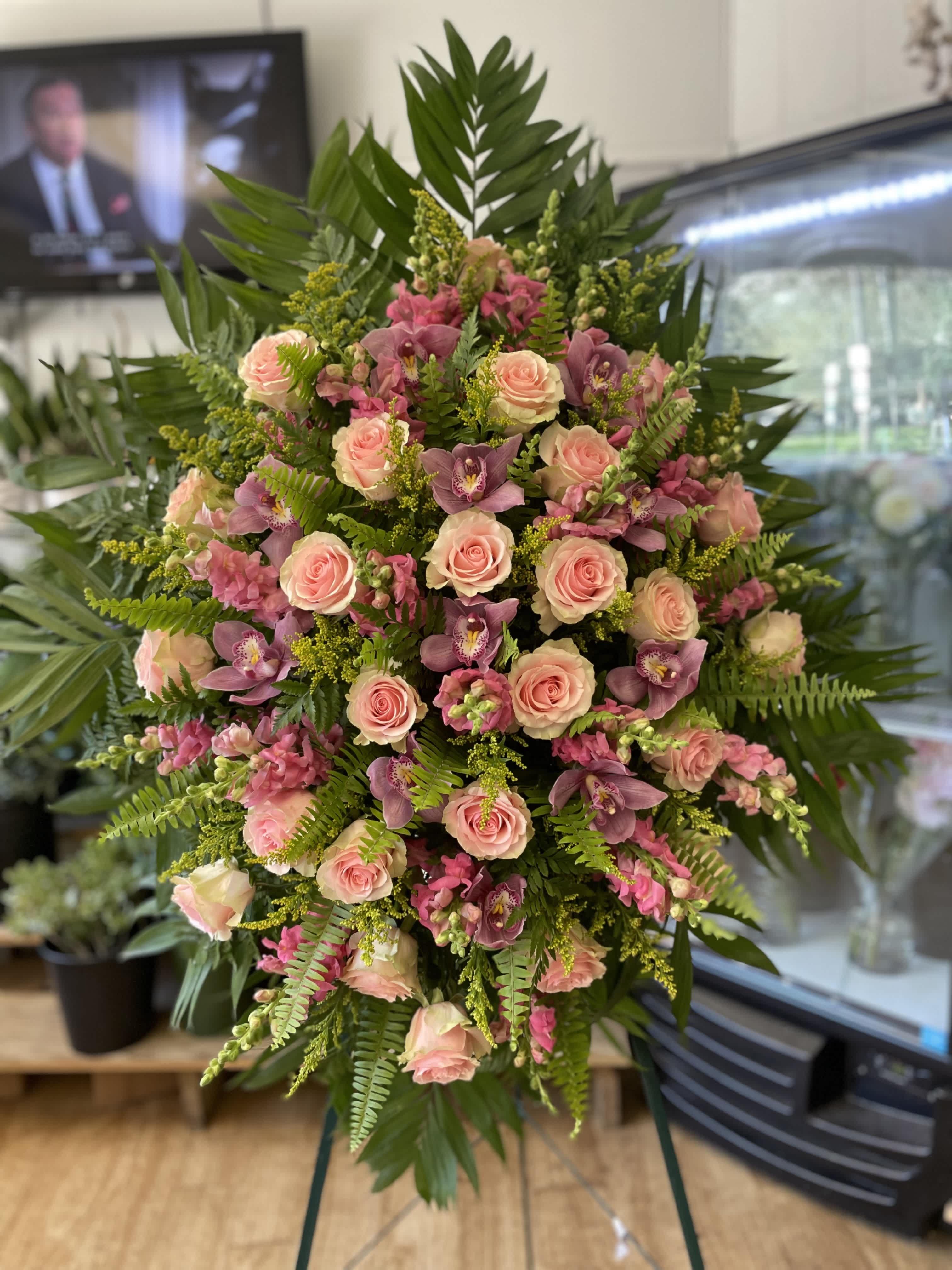Large standing spray of pink roses and purple orchids