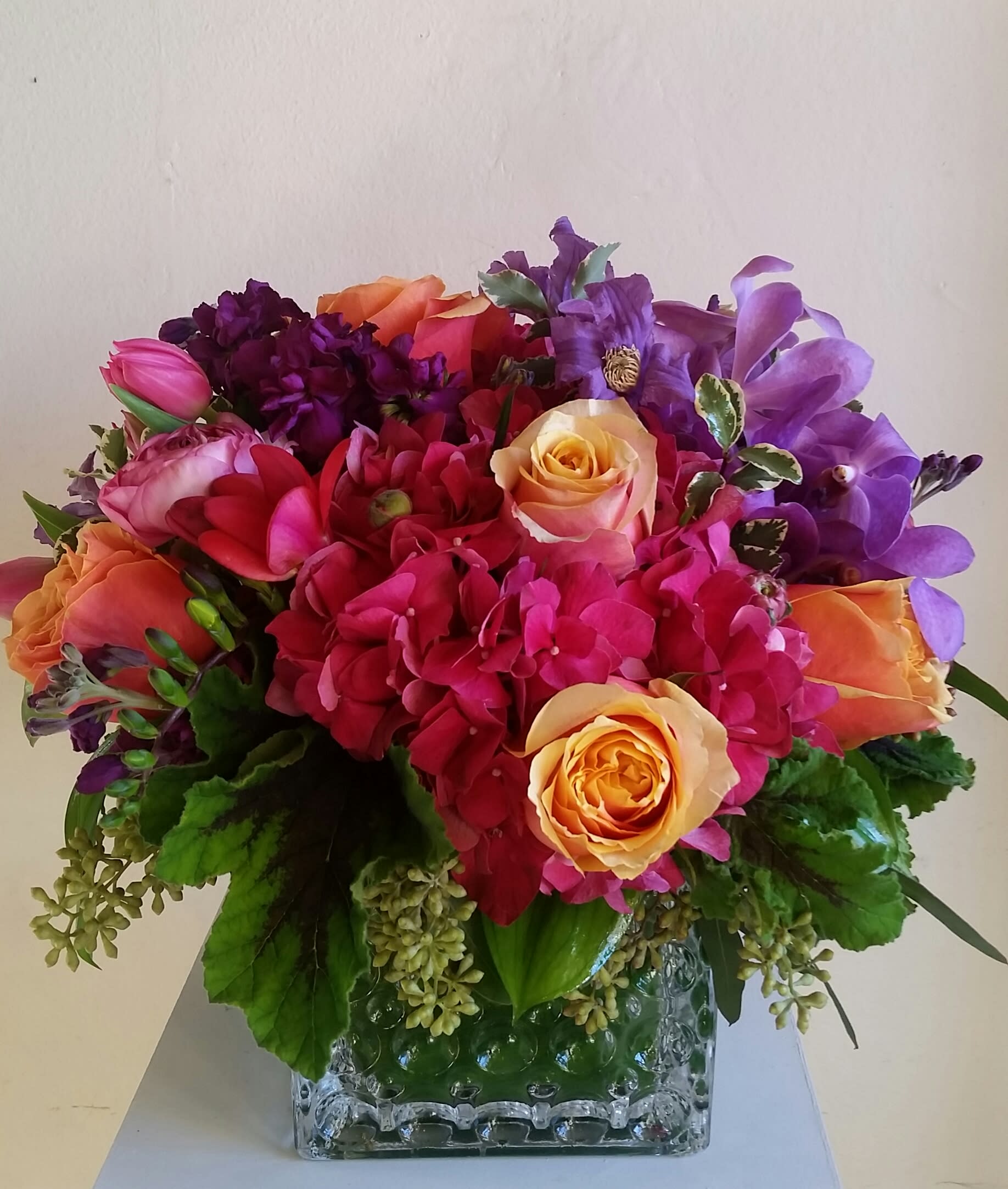 Color Pop - Bright, colorful arrangement with oranges, purples and hot pinks in a square or cylinder glass vase.