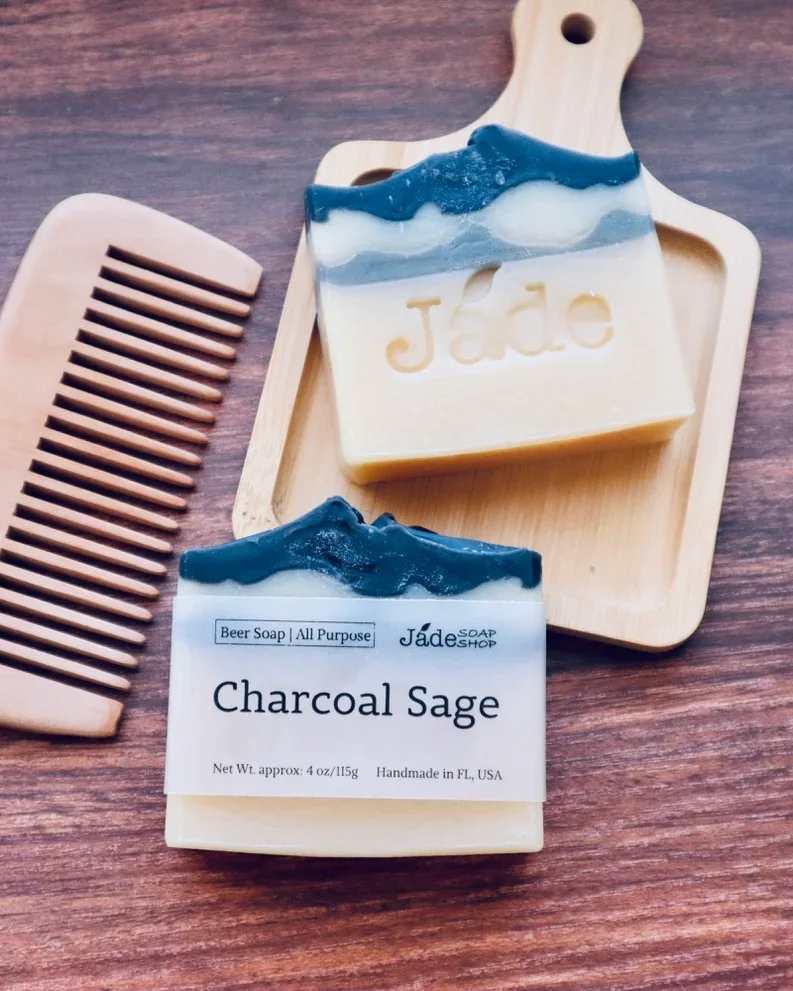 Charcoal Sage Beer Soap - All Purpose Premium Bar, made with local beer - All Purpose for head to toe; hair, face and body wash; made with local beer. Made with: Saponified Olive Oil, Coconut Oil, RSPO Palm Kernel Oil, Cocoa Butter, Hemp Oil, Castor Oil, High-Oleic Sunflower Oil. Activated Charcoal, Indigo. Essential Oils of Cedarwood, Clary Sage, Eucalyptus.  Fun Facts of Key Ingredients:  Beer has a lot of nutrients, such as vitamins and proteins. Beer can hydrate and nourish the hair. Not only that, it also clarifies the hair color and gives it major sheen. Many people use it to stimulate the growth of the hair, as well as a treatment for the frizz hair. Beer is also very beneficial for your skin as beer sediment or brewer's yeast helps reduce sebum production and control oily skin on your face or scalp. Activated charcoal draws bacteria, poisons, chemicals, dirt and other micro-particles to the surface of skin, helping you to achieve a flawless complexion and fight acne. Indigo Naturalis is an Ancient traditional skin remedy from Asia used safely and effectively for generations. Clary sage oil helps stimulate your hair follicles for healthy hair growth. It strengthens hair, creates the perfect environment for hair elasticity, and also reduces shedding. It is also a natural antibacterial essential oil that helps combat bacteria and microbes that trigger scalp infections.  ** Jade Soap Shop uses Sodium hydroxide for saponification. There's no sodium hydroxide exits in the soap after the saponification is done.  Weight:  3.5-3.75 oz