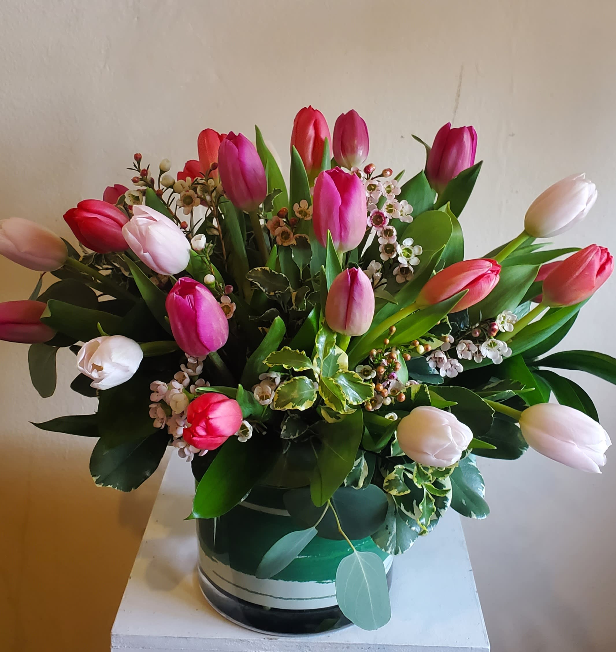 Bouquet of pink and white tulips in a round vase