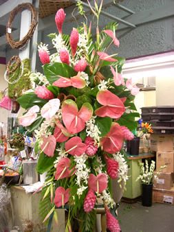 Tall tropical arrangement with pink anthuriums and white flowers