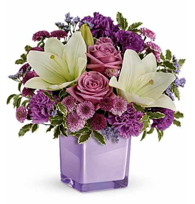 TF Pleasing Purple Bouquet - Lavender roses, white asiatic lilies, purple carnations, lavender carnations, purple button spray chrysanthemums and lavender button spray chrysanthemums are arranged with lavender limonium and pitta negra.