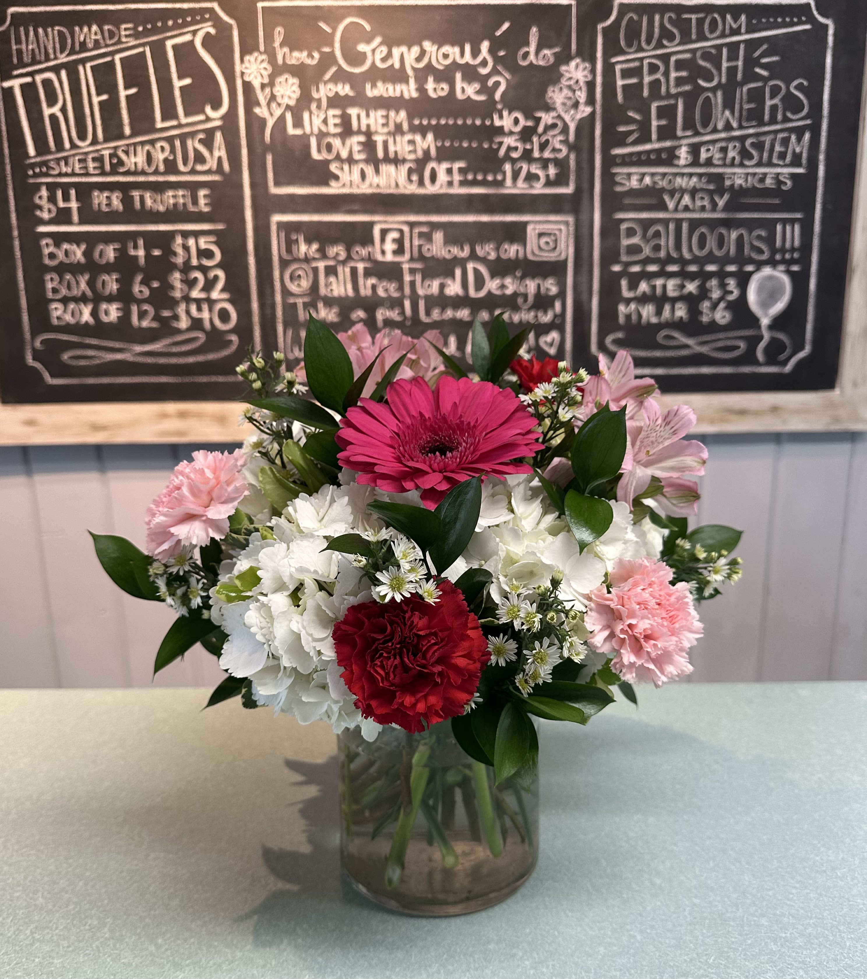 Hugs &amp; Kisses - White hydrangea, red and pink carnations, hot pink gerbera daisy with white monte casino asters in a clear cylinder vase