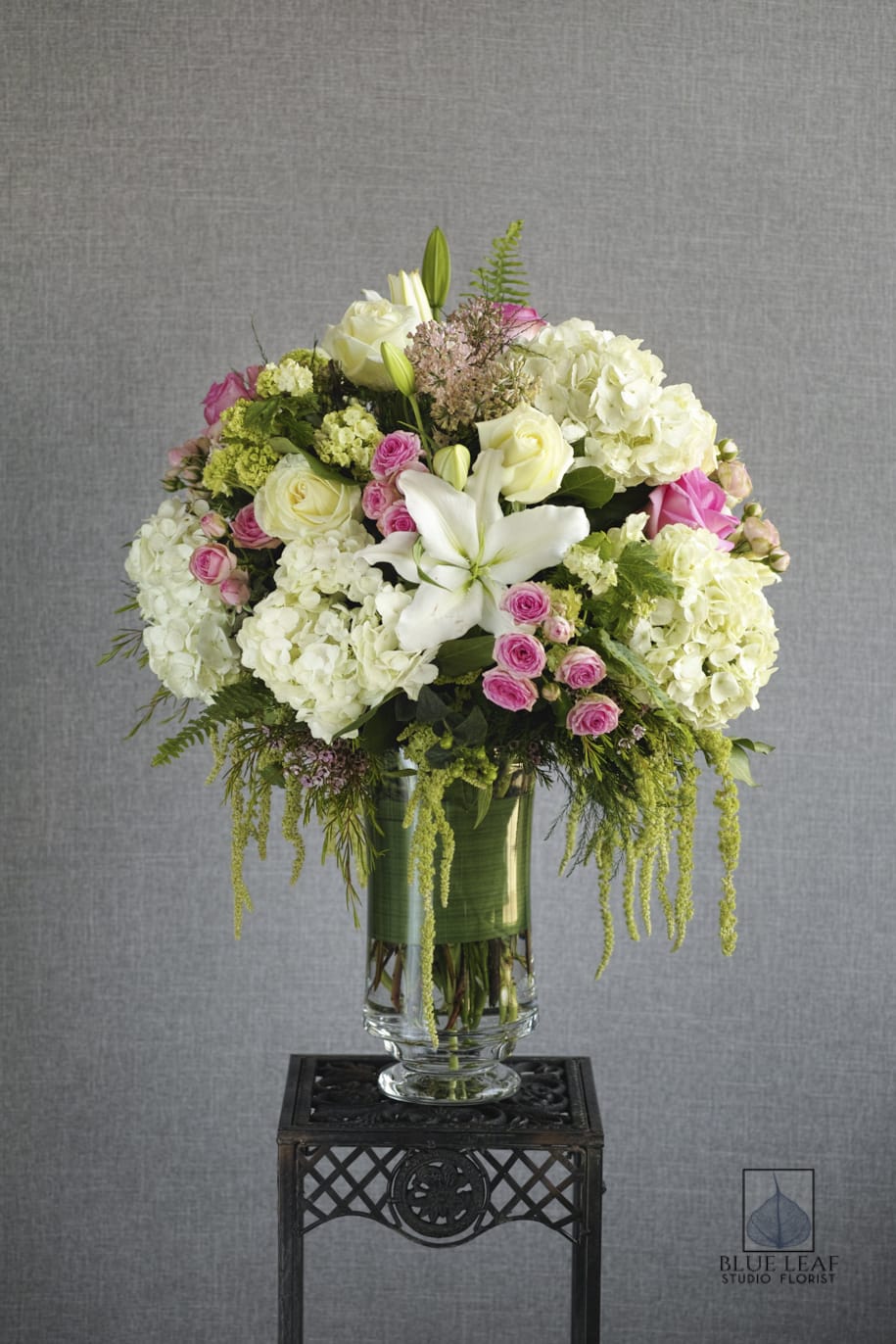 White and pink floral arrangement in a glass vase