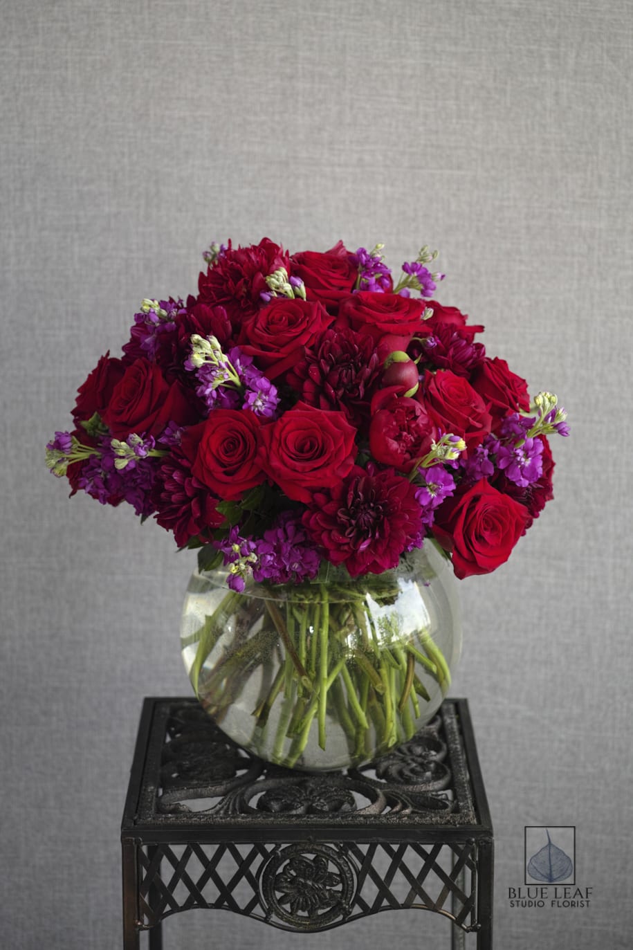 Red Elegance - Compact, with beautiful roses, daliahs(seasonal) and red peonies. Note: Some of these flowers are seasonal and will require extra time to ensure a close match
