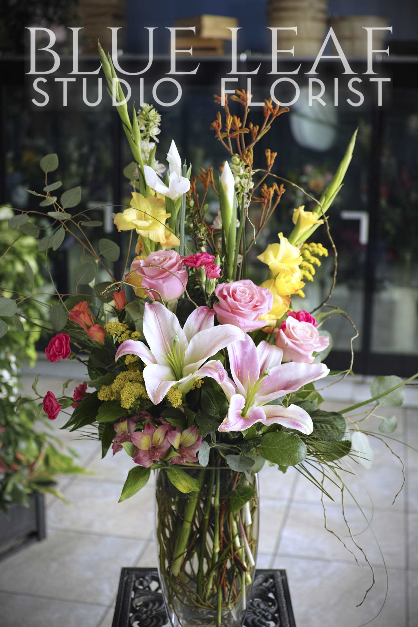 Spring Song - Tall arrangement of lilies, gladiolas, roses and assortment of  complimentary flowers.