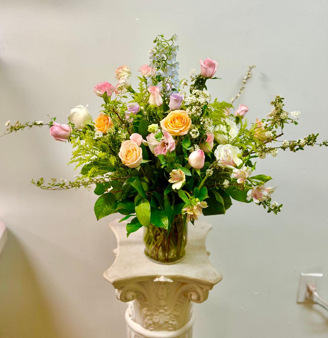 Summer Blossoms - Theme Colors: Shades of pink, purple and yellow.  Featured Blooms: Roses, Spray Roses, Lisianthus and blossoms, greenery.  HK Flowers have a uniqueness of florals and seasonal blooms, certain flowers or colors may not be available as each season affects the availability, color, size, and shape of each floral bloom. Some flowers may be substituted accordingly.  Photos are used as a reference for the color palette and is NOT indicated of the final product. We ask for your trust in us that we will pick out the best seasonal available blooms, while still capturing the arrangements' theme and colors mentioned above.