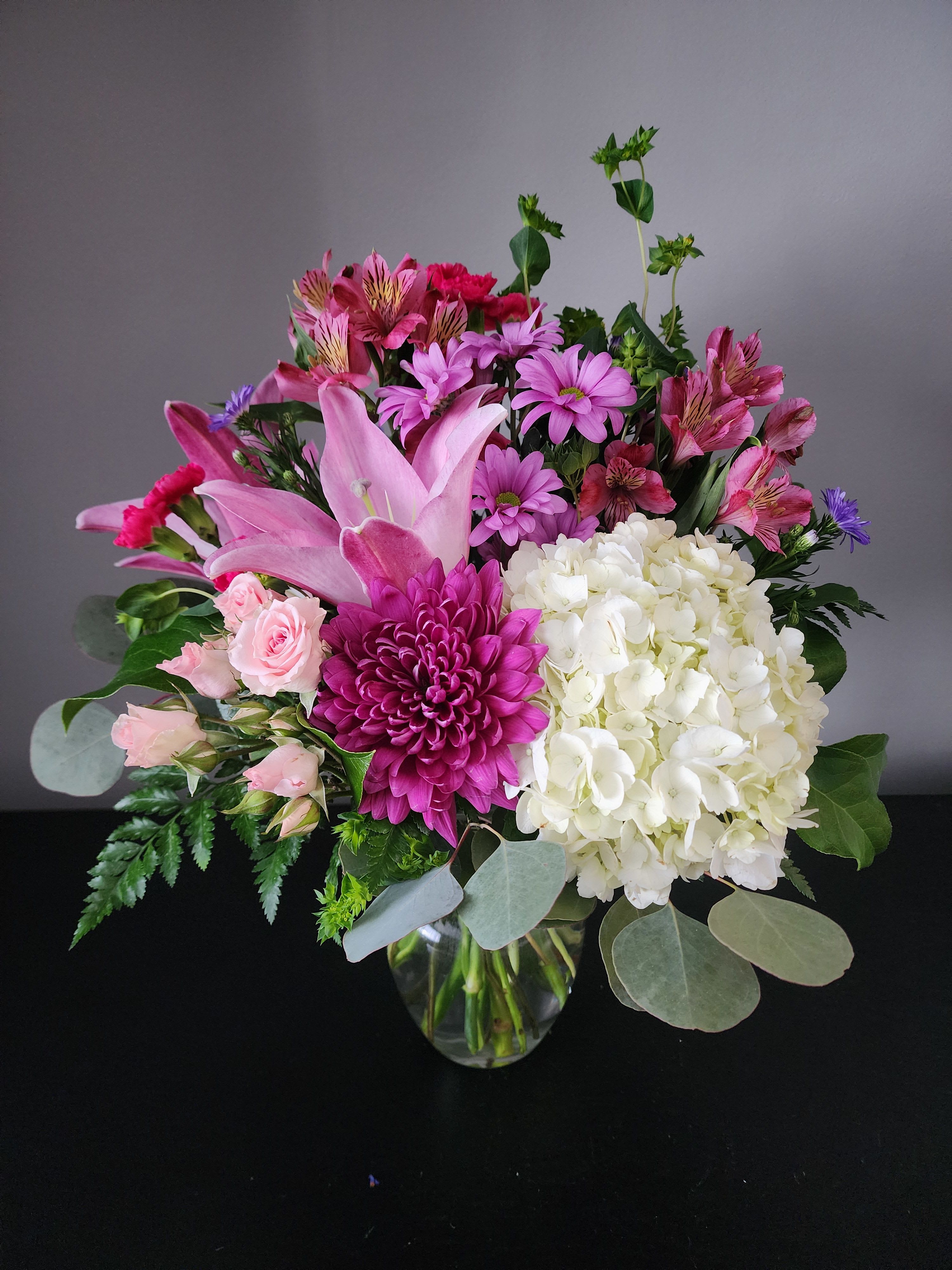 Pink and white mixed bouquet in a clear glass vase