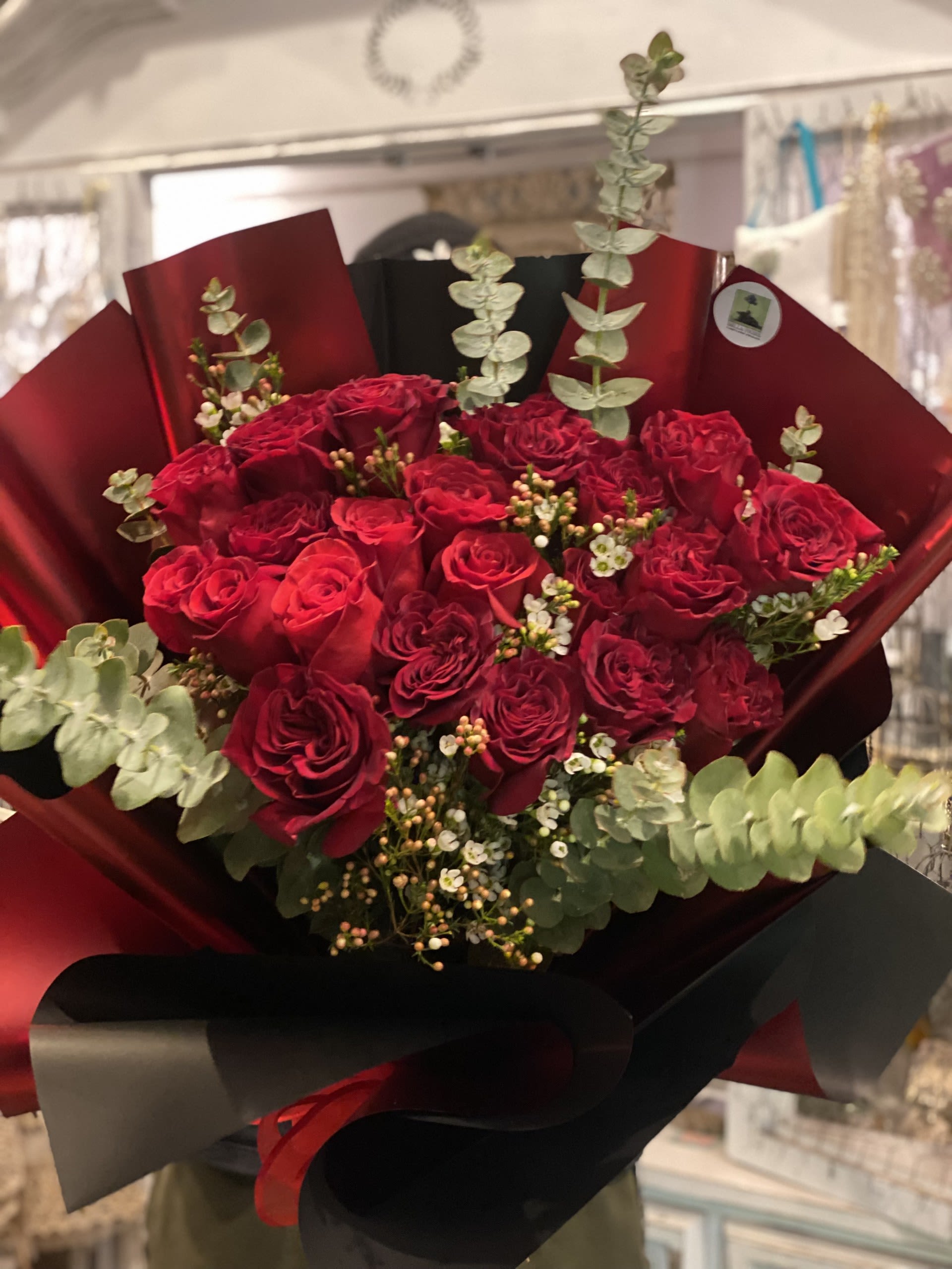 Eternal Red  - Bold red roses wrapped in deep burgundy paper(variety of colors), accented with fresh eucalyptus. A dramatic, modern statement of love and elegance.