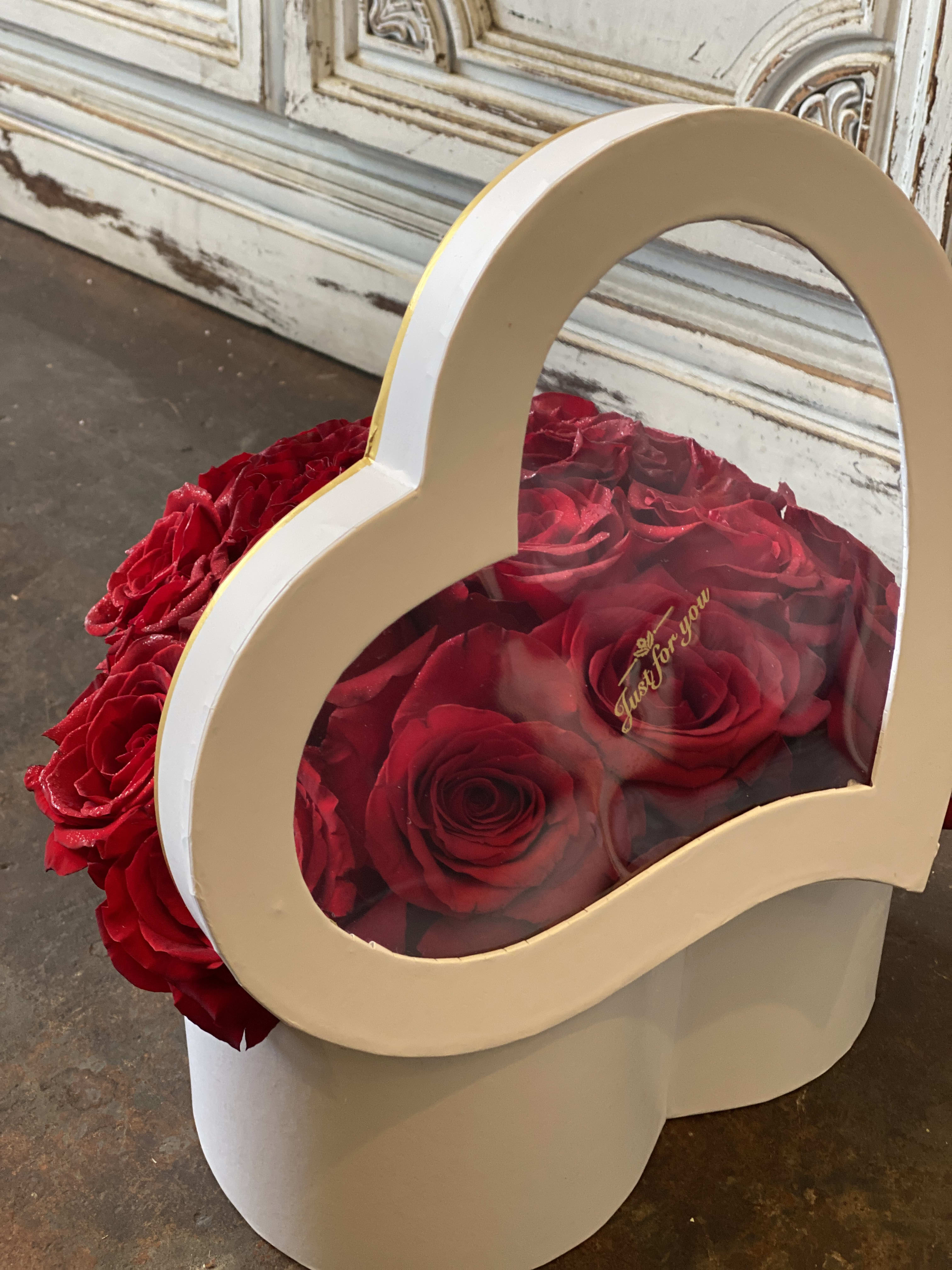 Heart Shaped box - Heart Shaped box filled with roses. Box colors to choose from: red/whit. Rose colors to choose from: red/pink/hot pink/lavender/white, colors may be subbed based upon availability. 