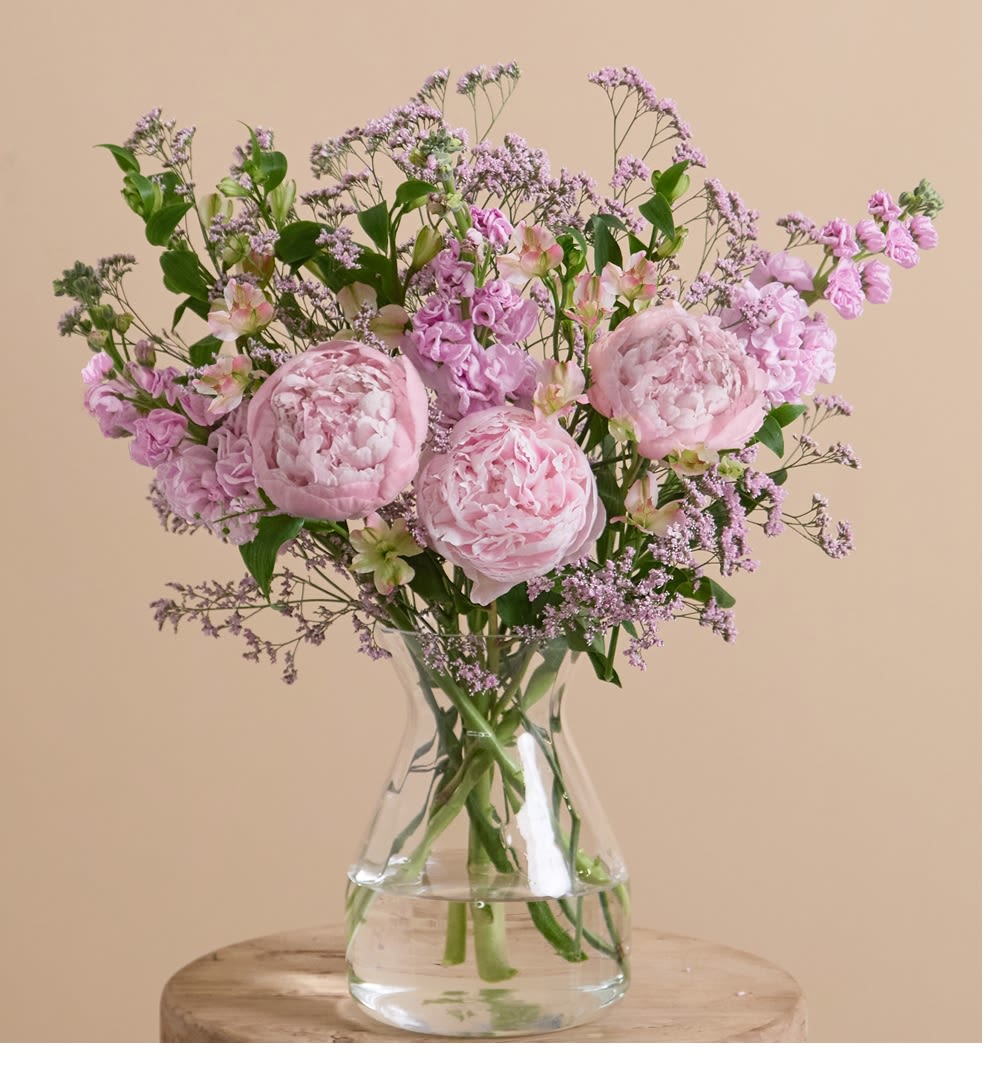 Painterly Pink - Pink petal pops on a lush green canvas, this arrangement features billowing peonies in a playful and expressive composition of pink stocks, alstroemeria, and limonium.