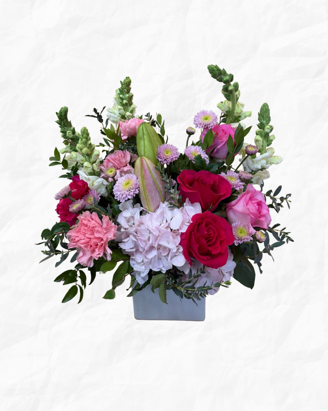 Pink and white floral arrangement in a gray vase