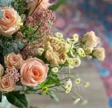 Bouquet of pale pink roses and cream flowers with small filler blooms