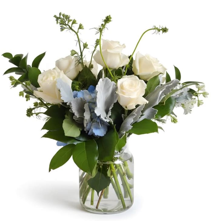Bluebird Grace - Clean, classic, and quietly stunning. Bluebird Grace features crisp ivory roses, soft blue hydrangea, and airy garden textures for a design that feels fresh, elegant, and effortlessly serene. Perfect for thoughtful gestures, sympathy, or timeless everyday beauty.