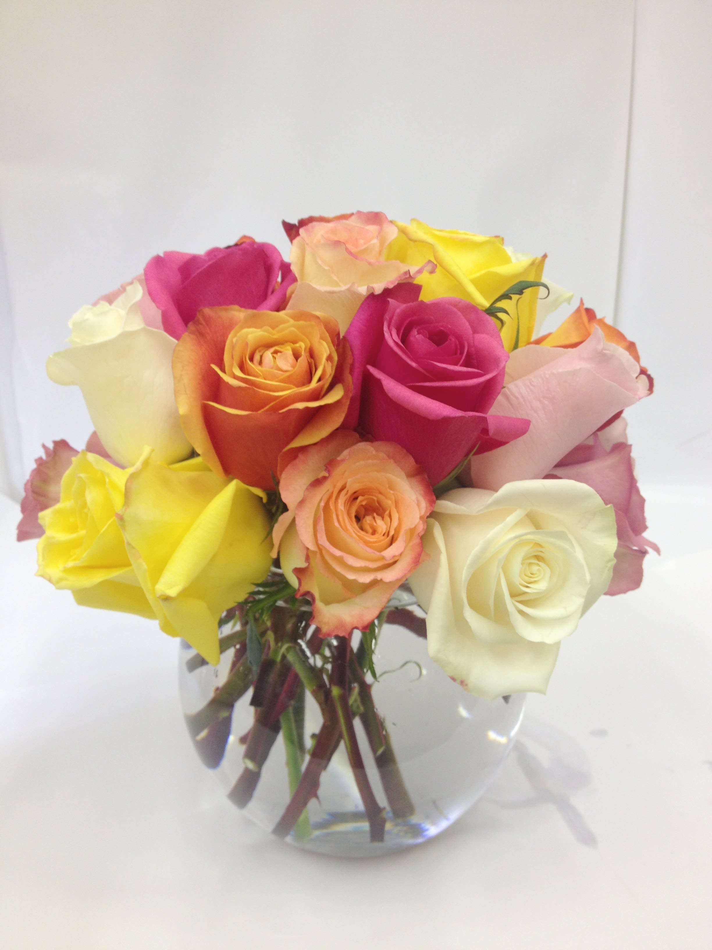 Bouquet of multicolored roses in a clear glass vase