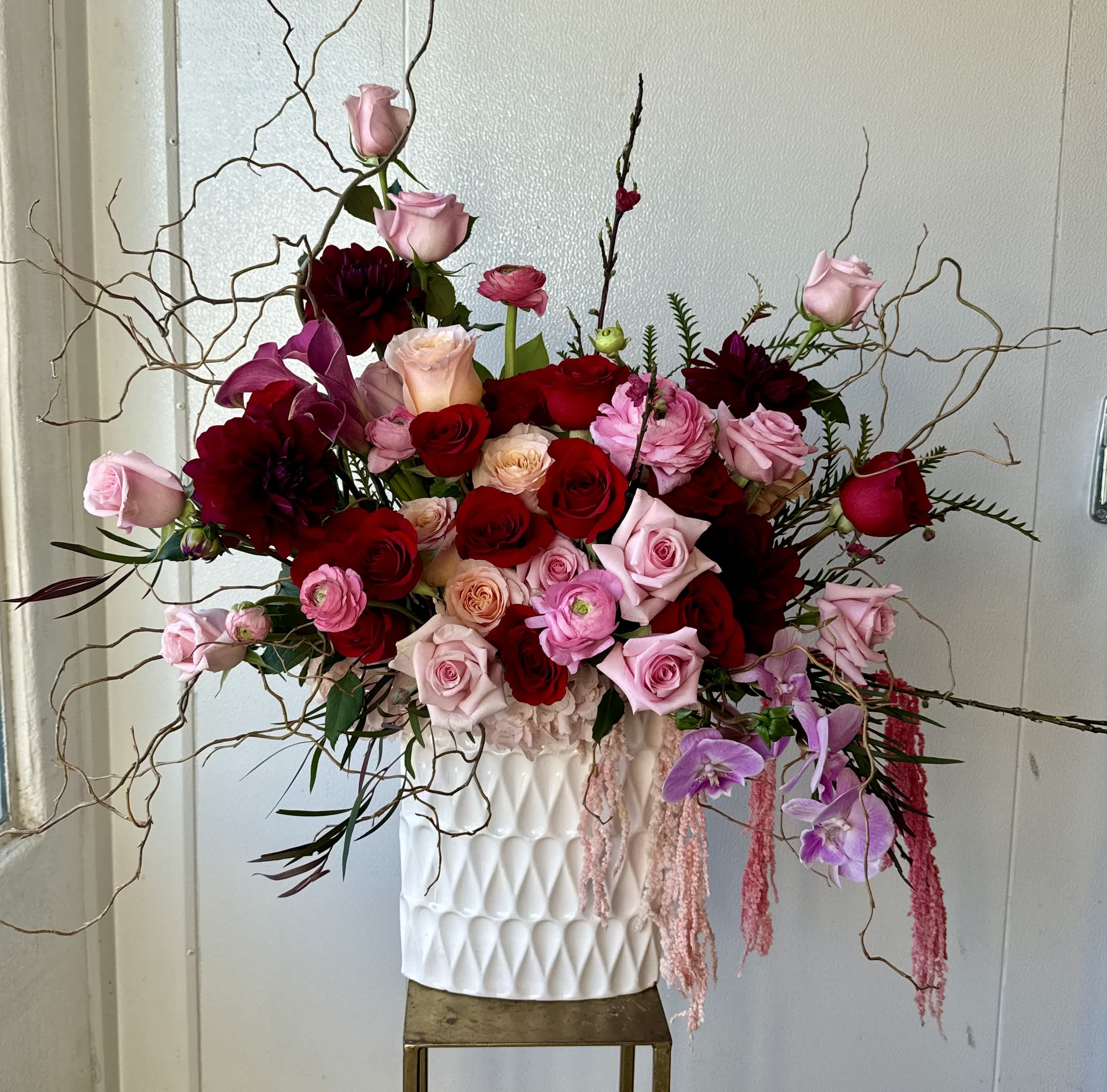 Large bouquet of pink and red roses in a white vase