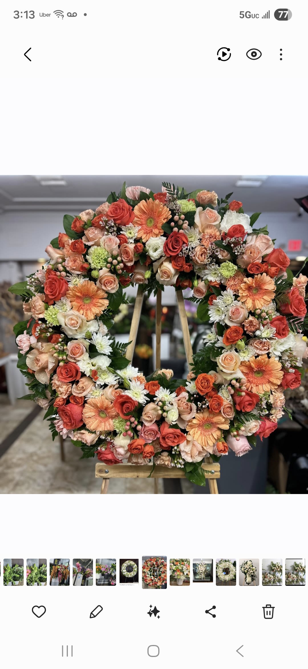 Large floral wreath with roses, gerbera daisies, and small filler flowers